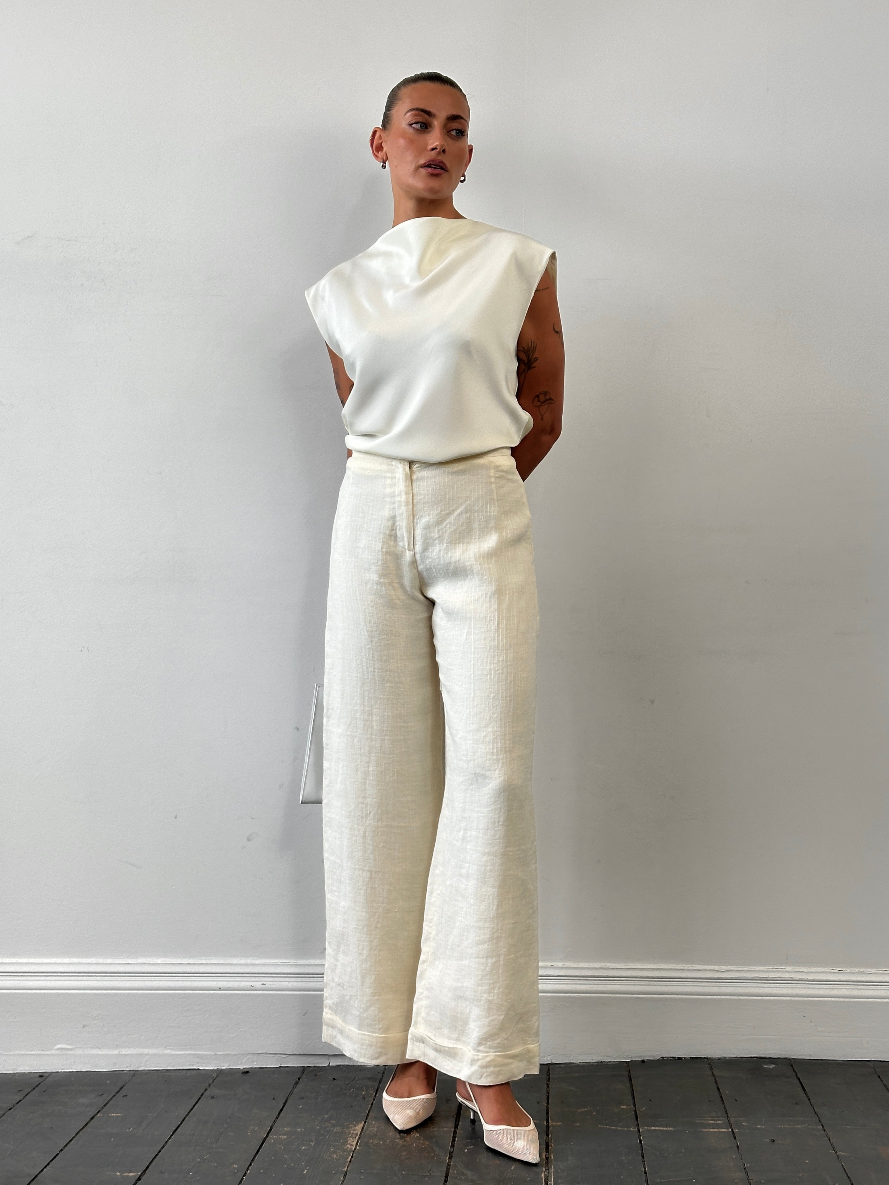 Vintage high-waisted wide-leg tailored trousers in W26, showing the classic fit and fabric texture.