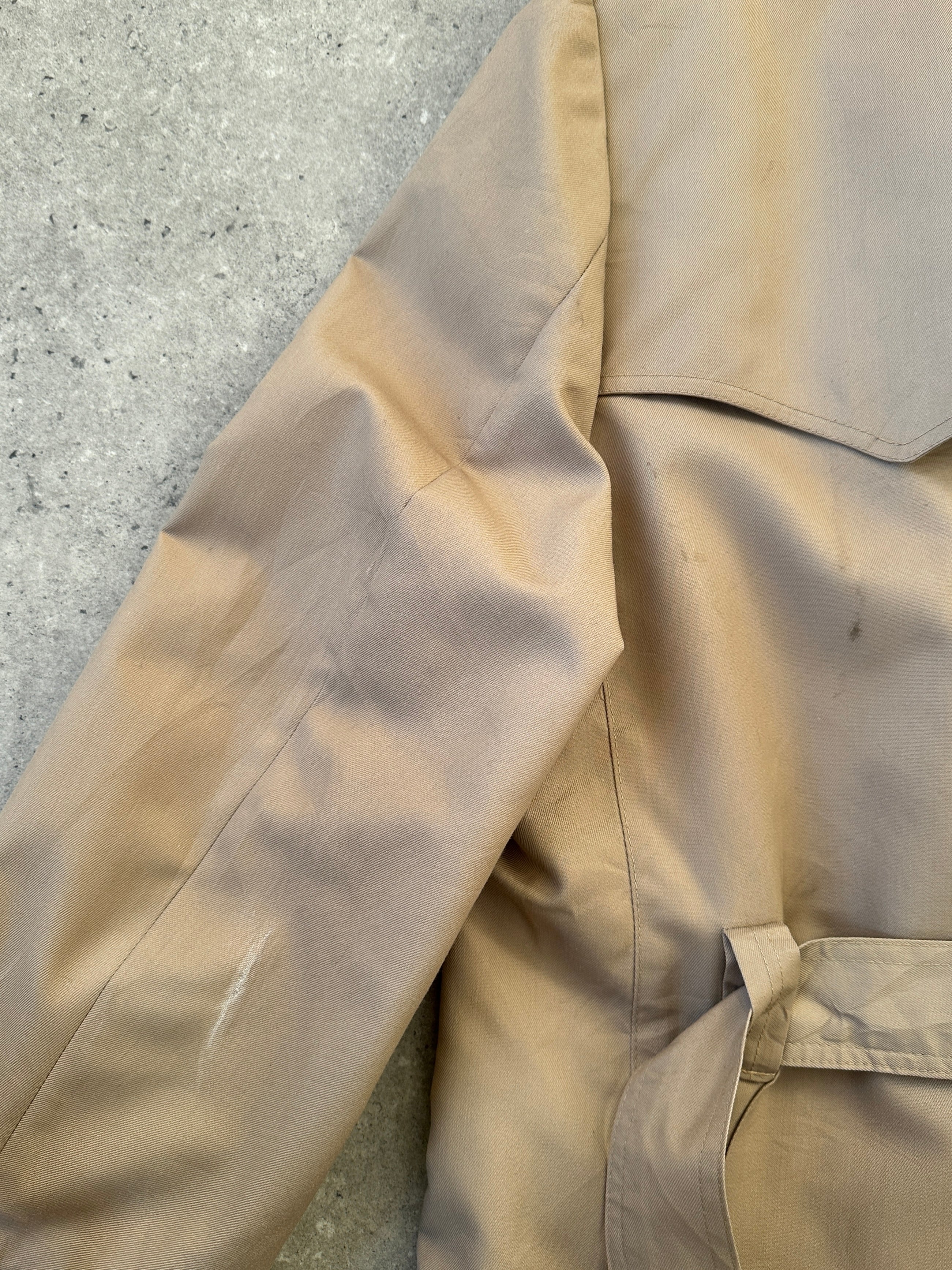 Christian Dior double-breasted cotton trench coat with belt, in size M, featuring classic design and neutral color.