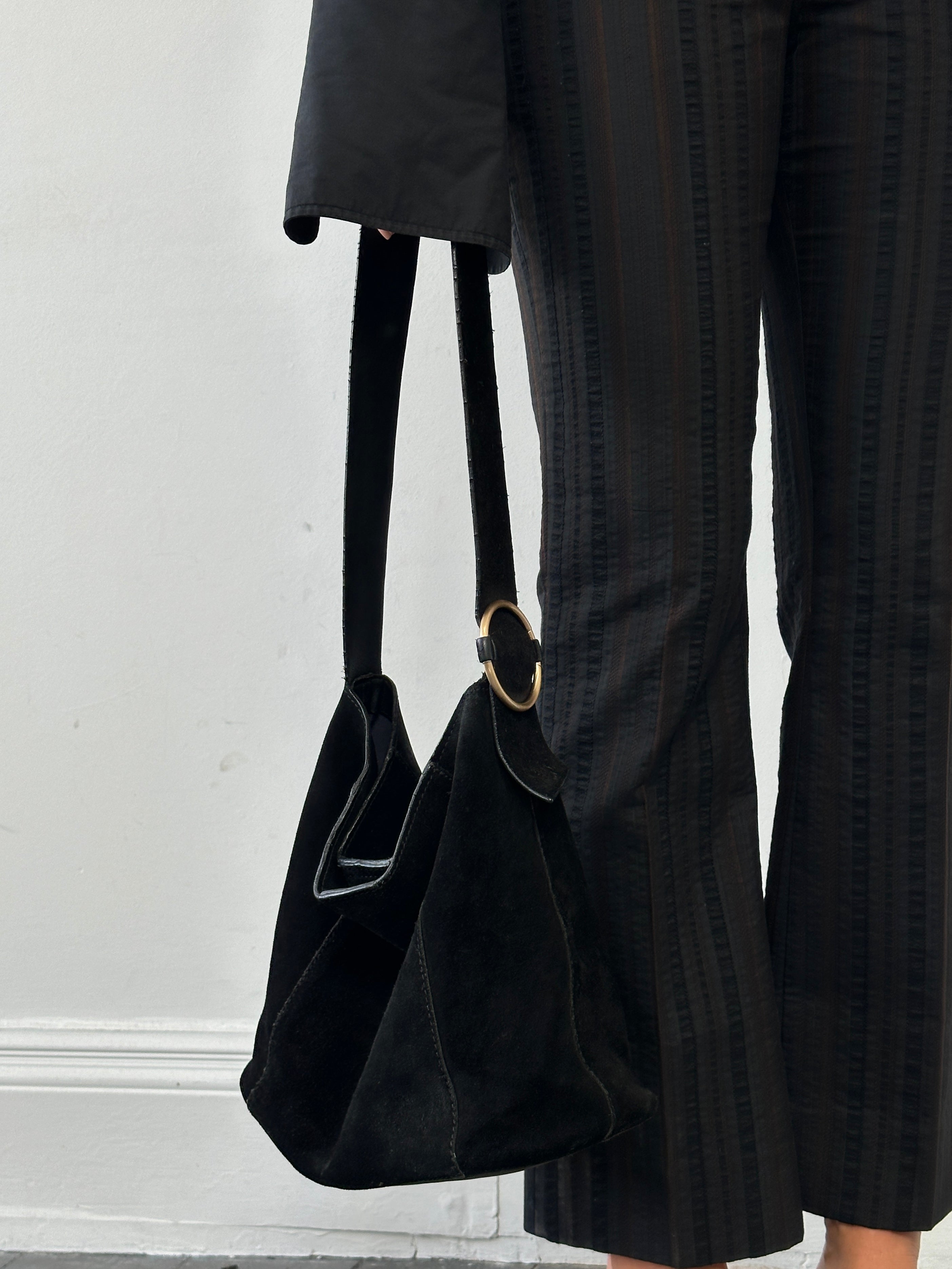 Vintage Maison de Nimes suede bucket bag with a rounded shape and drawstring closure, showcasing soft tan suede material.