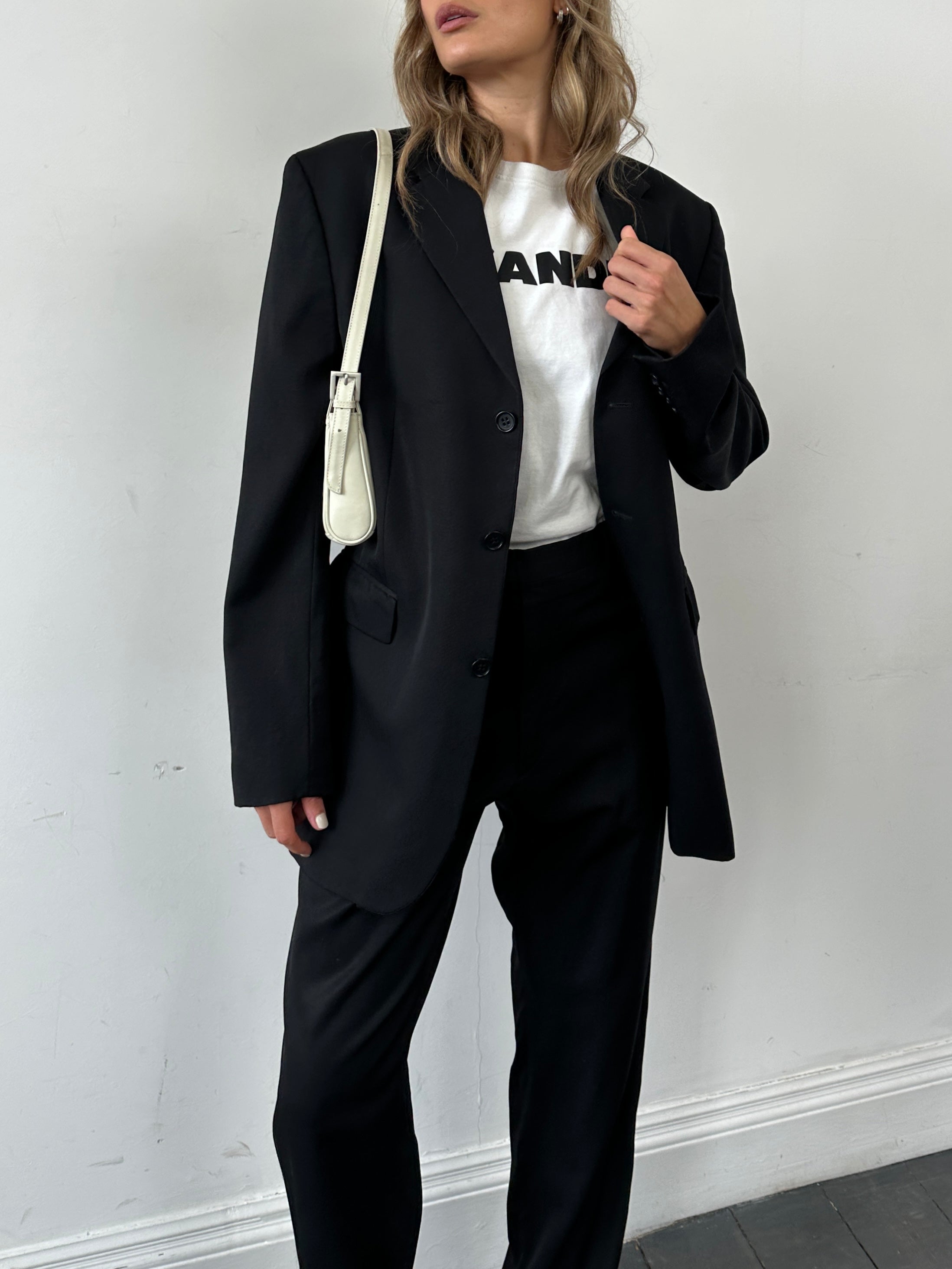 Yves Saint Laurent Pour Homme pure wool single-breasted suit in size 42R/W34, displayed on a hanger.