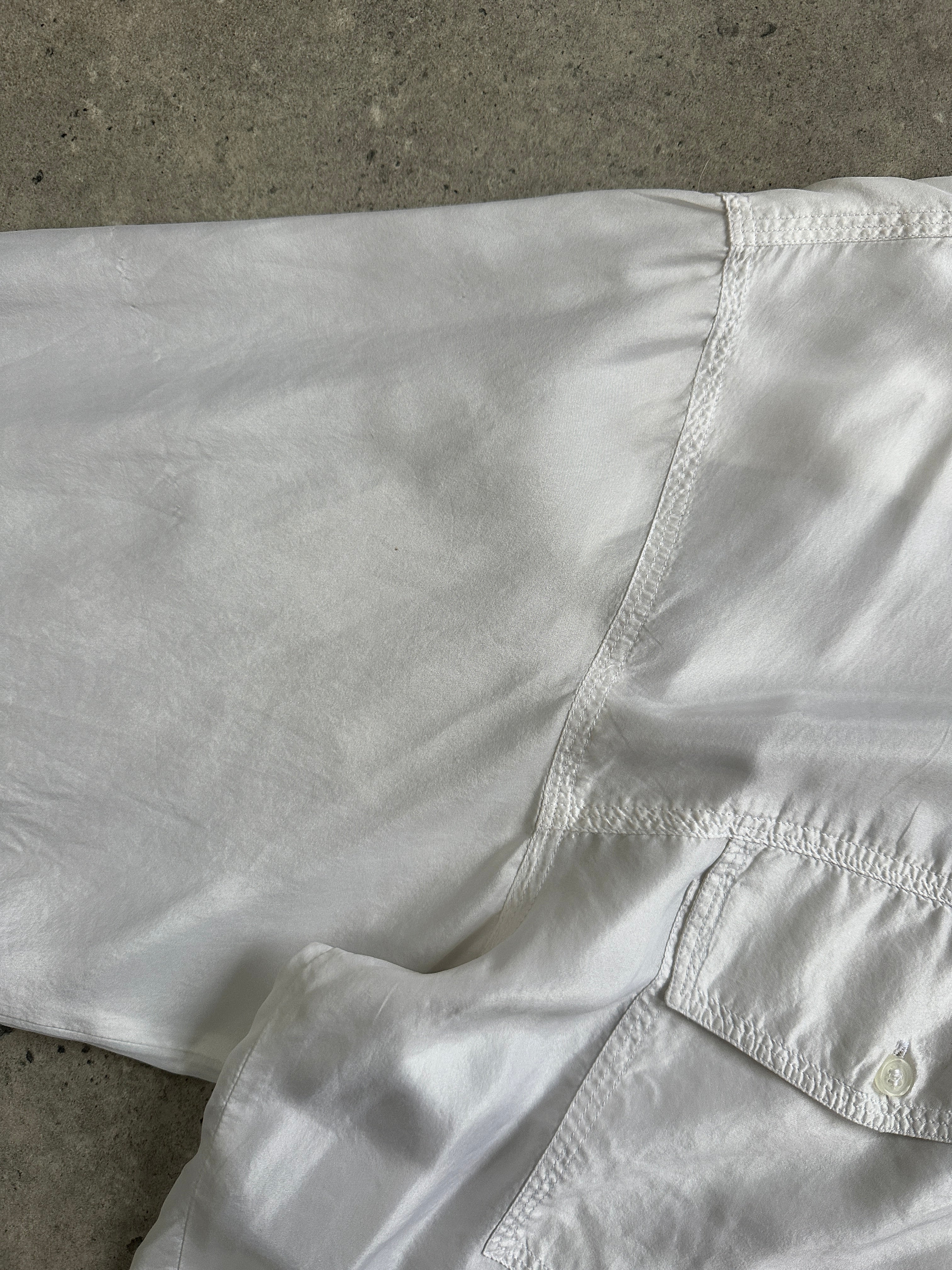 Vintage 1990s pure silk shirt in XL size, featuring a classic design and smooth fabric, displayed on a hanger.