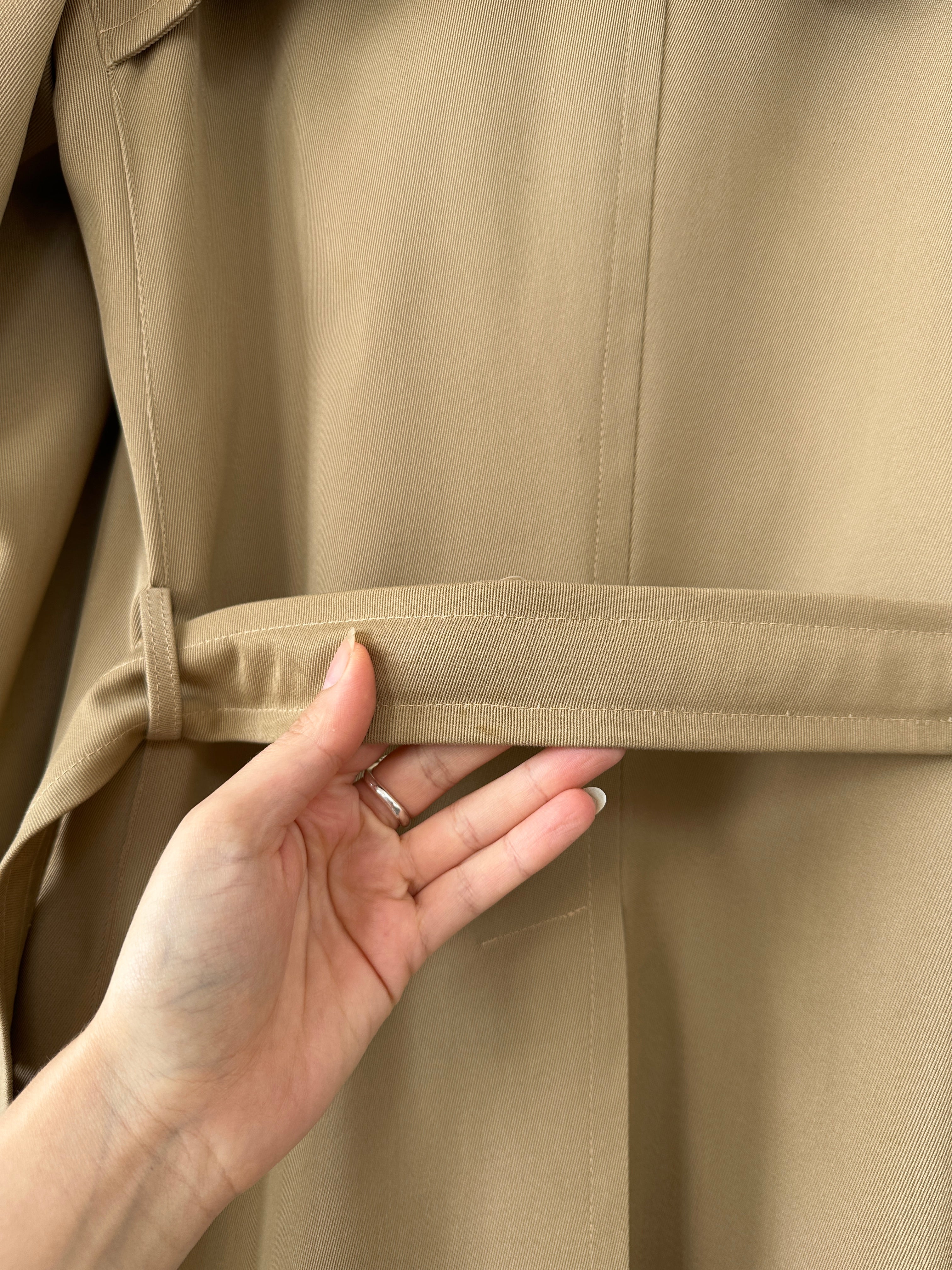 Vintage wool double-breasted trench coat in size L, featuring classic design and tailored fit, displayed on a neutral background.