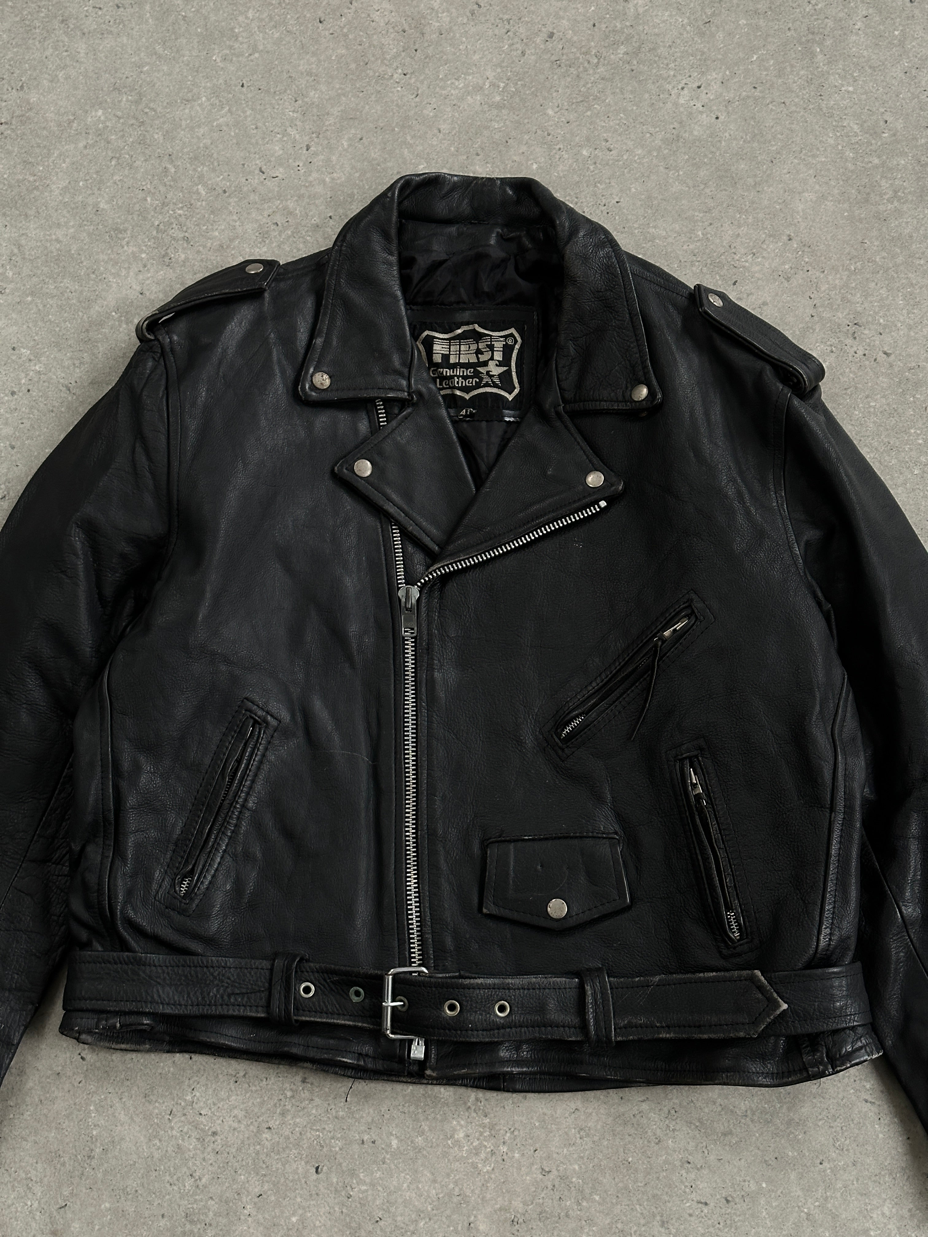 Vintage leather biker jacket in XL size, featuring classic design with metal hardware and distressed finish.