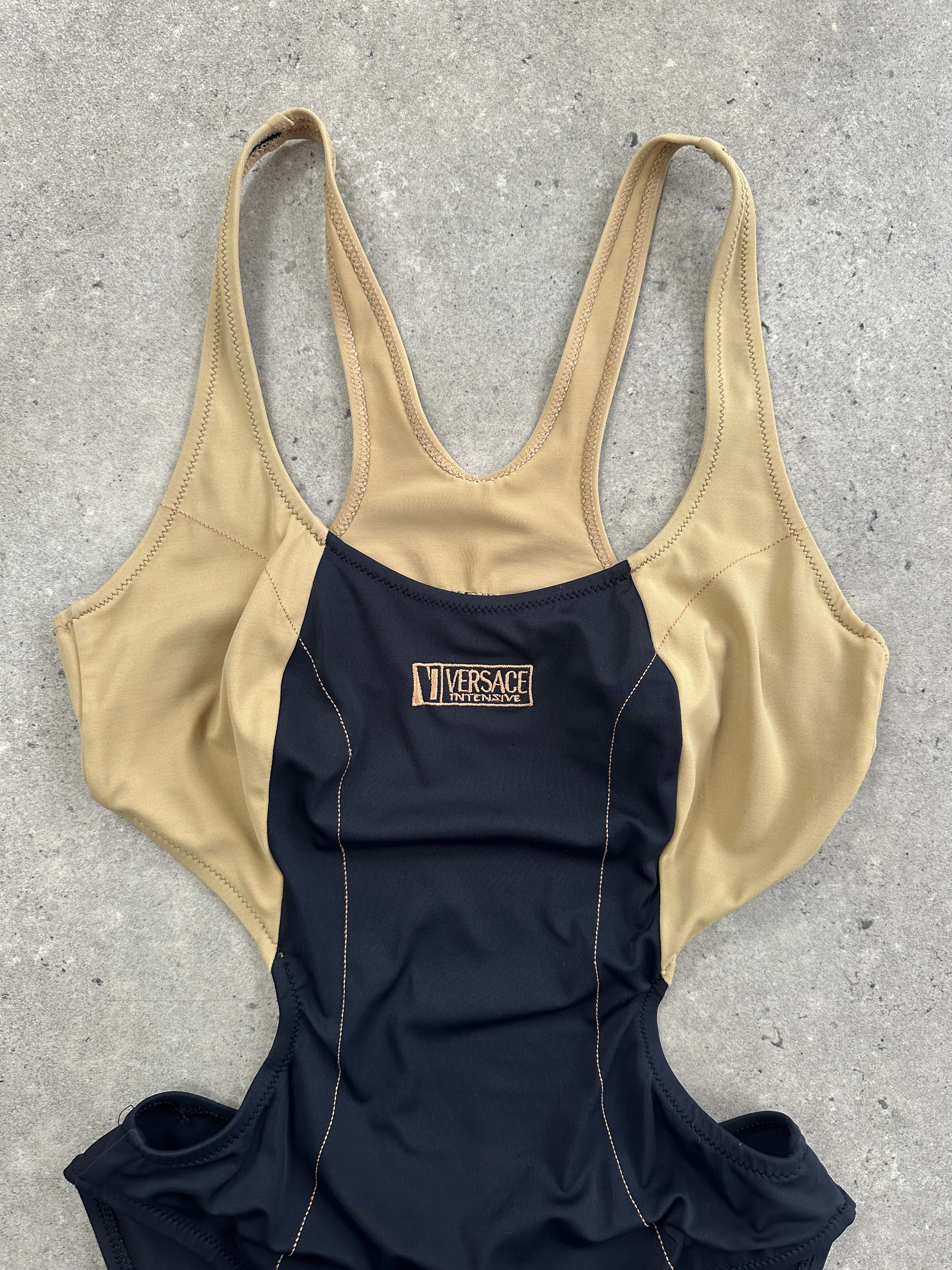 Versace Intensive 1990s high-cut logo one-piece swimsuit top with bold branding and sleek design, in black color.