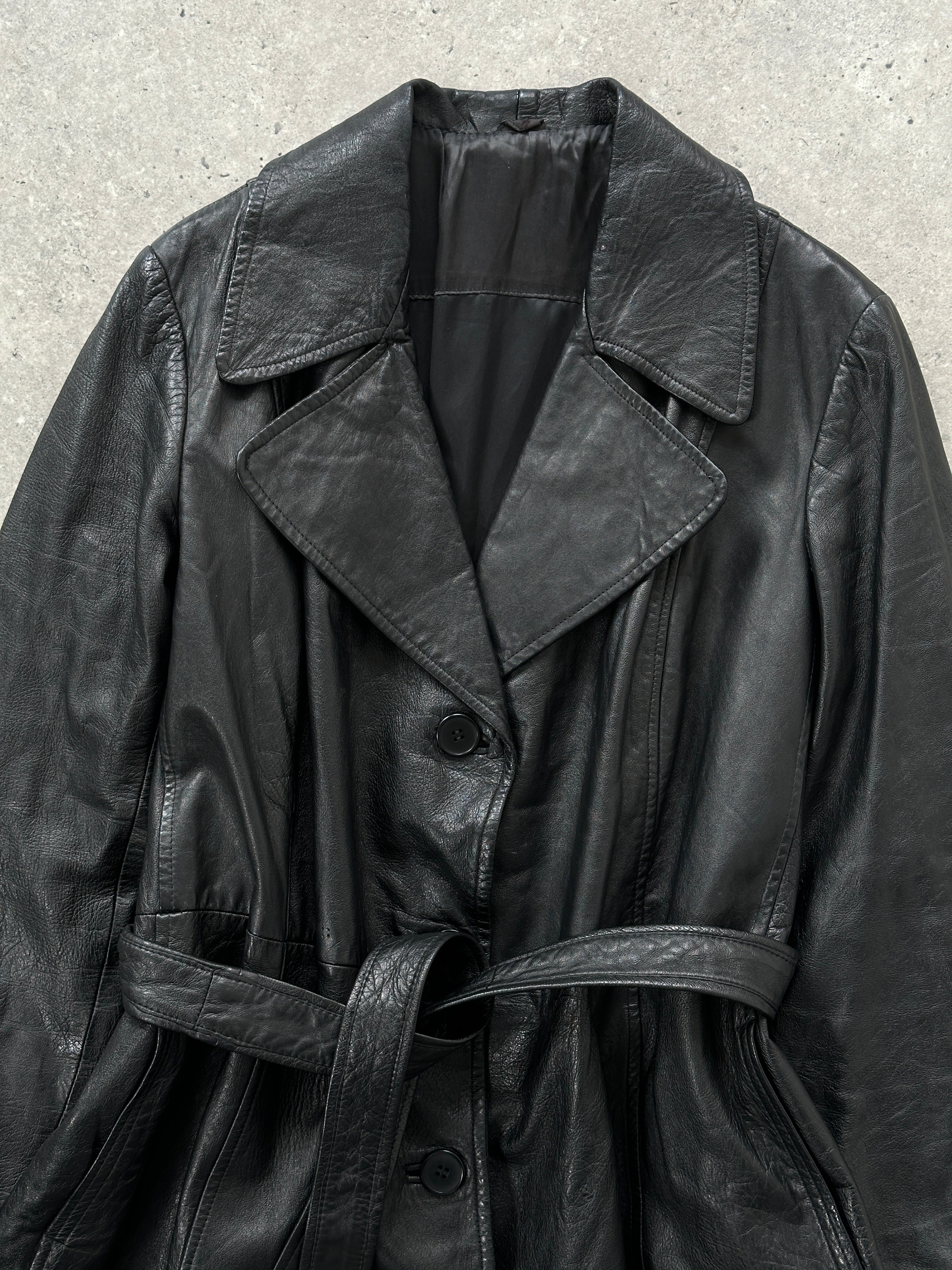 Vintage leather trench coat with belt, long sleeve design, classic style, in a muted brown color, displayed on a hanger.