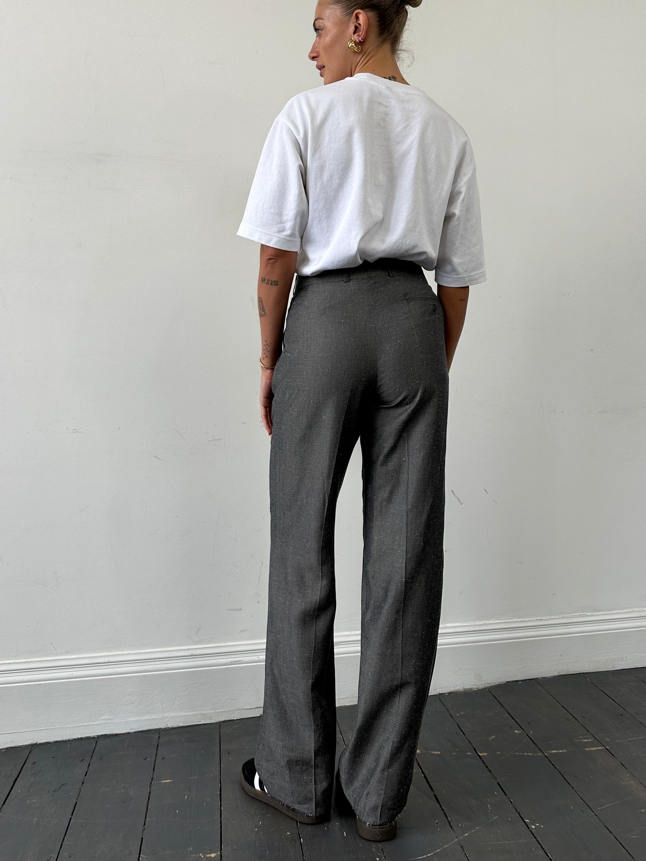 Vintage Italian high waisted tailored trousers with straight legs, raw hem detail, styled in classic vintage fashion.