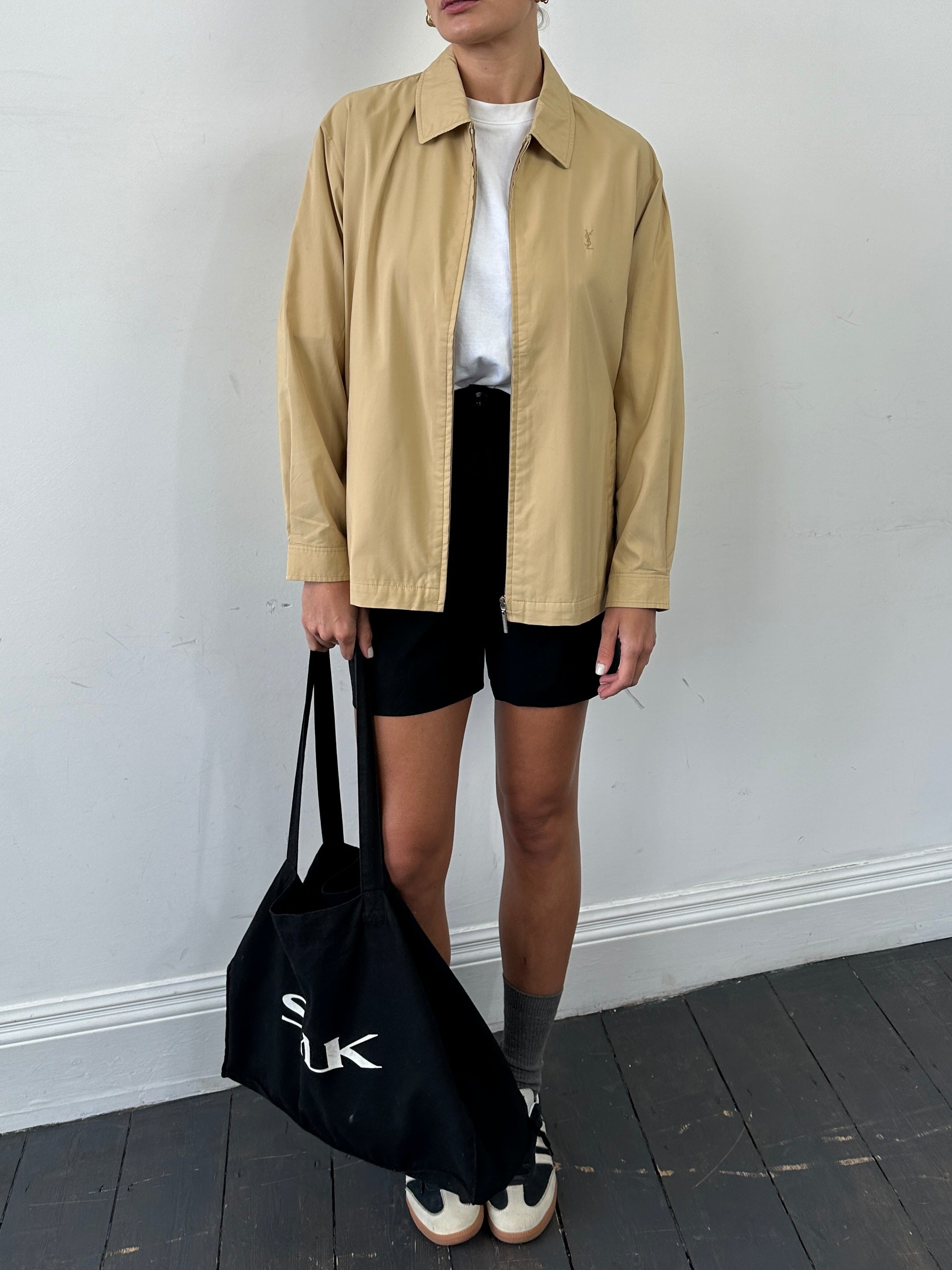 Yves Saint Laurent Pour Homme showerproof logo bomber jacket in size L, black with YSL branding and ribbed cuffs.