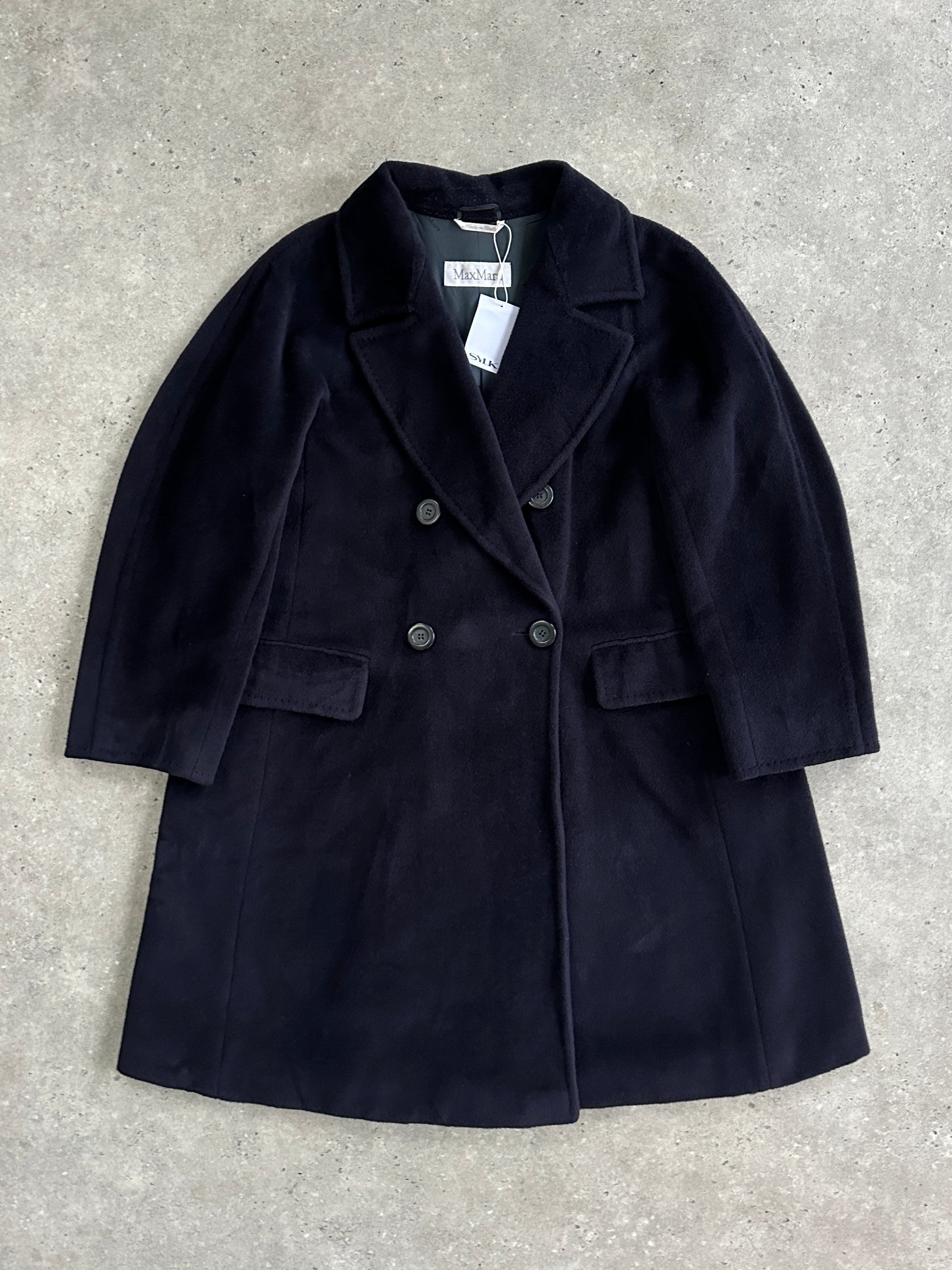 Max Mara wool and cashmere double-breasted A-line coat in size L, shown hanging on a wooden rack.