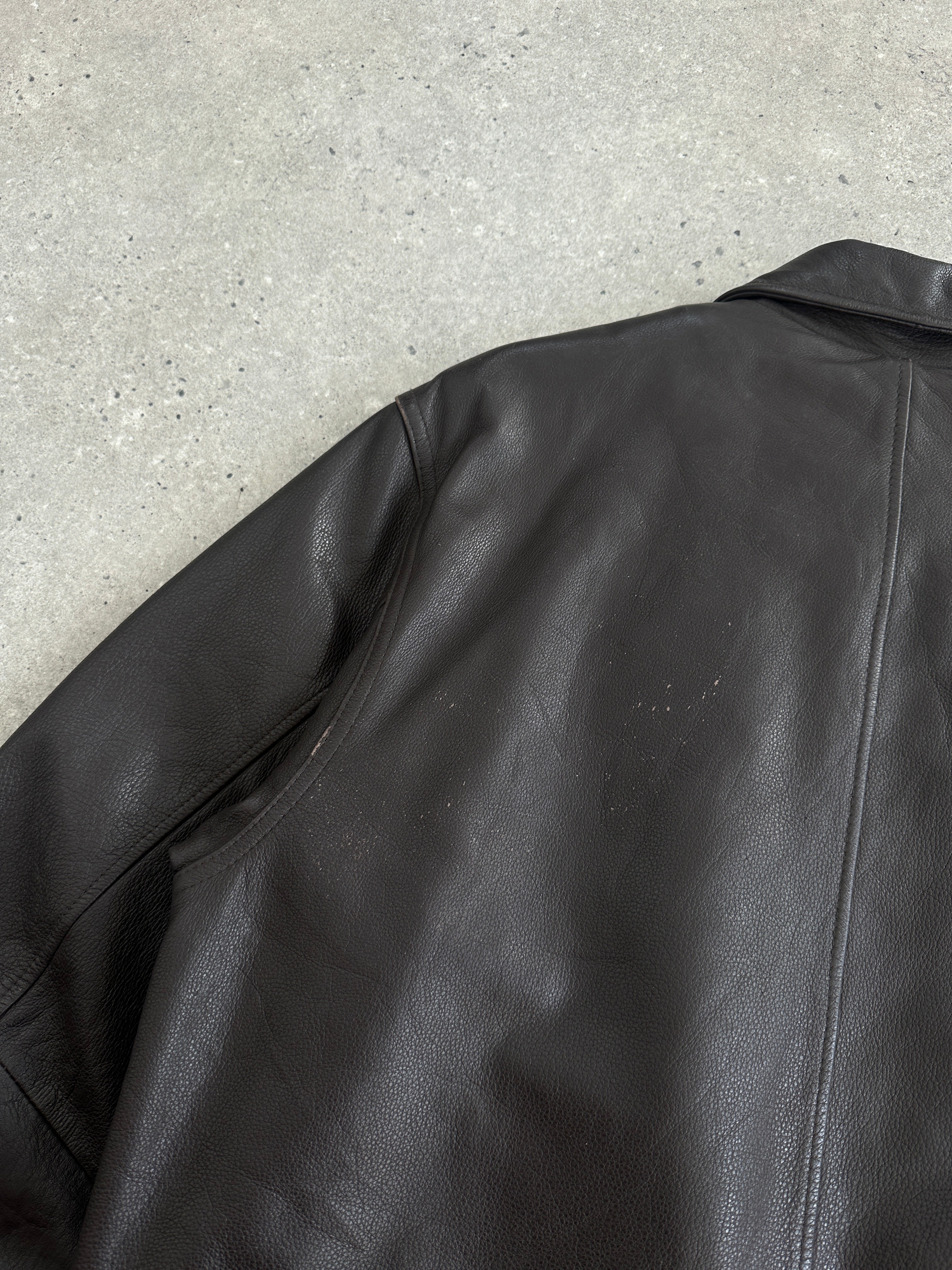 Vintage brand boxy leather jacket in size large, featuring classic design and textured brown leather.