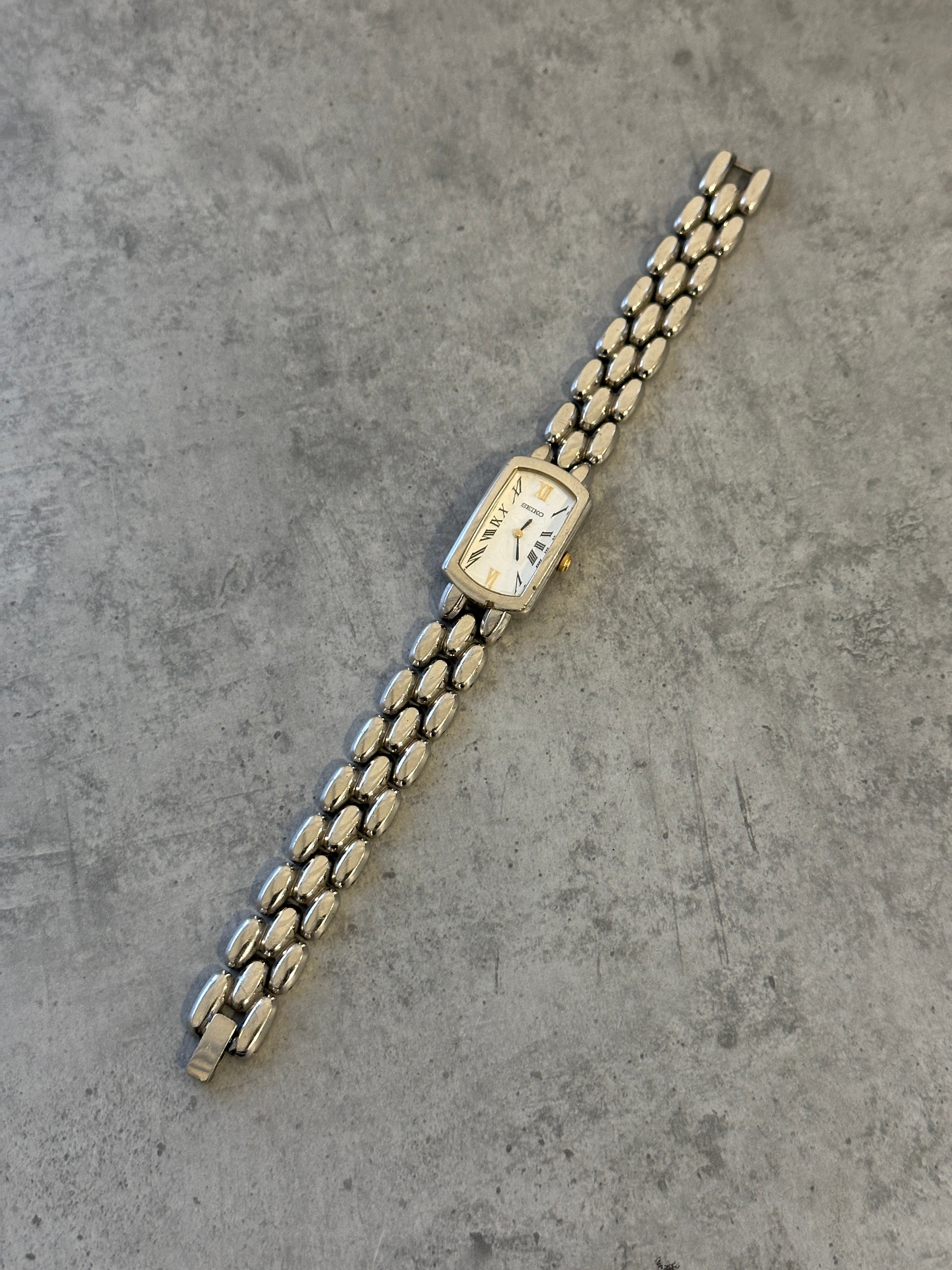 Seiko 1990s stainless steel rectangular quartz watch with classic design and silver-tone finish.