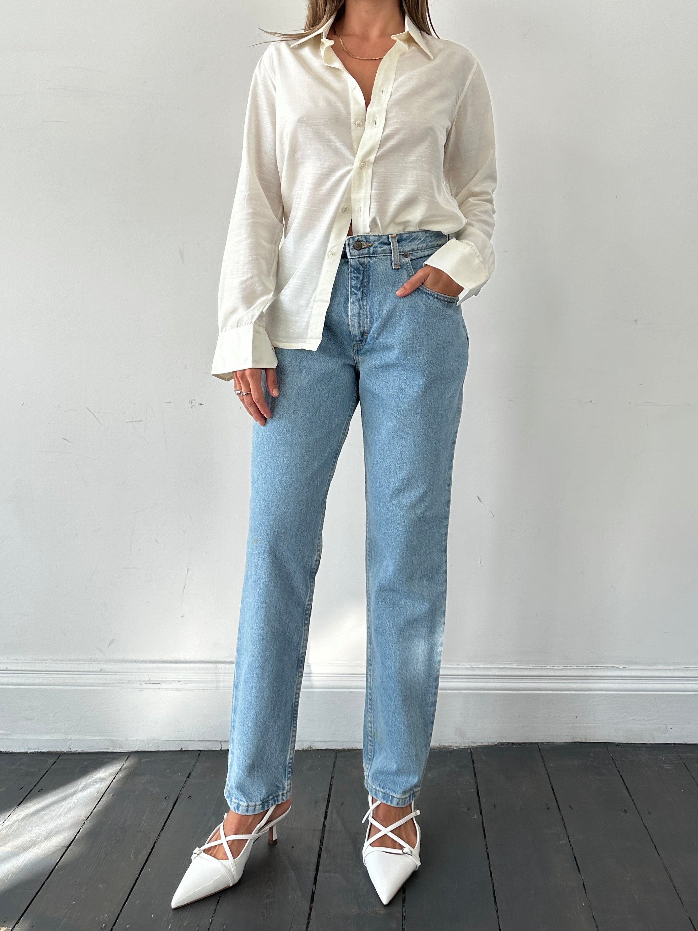 Light wash Lee high waisted denim jeans in size W30, showing the classic fit and detailed stitching.