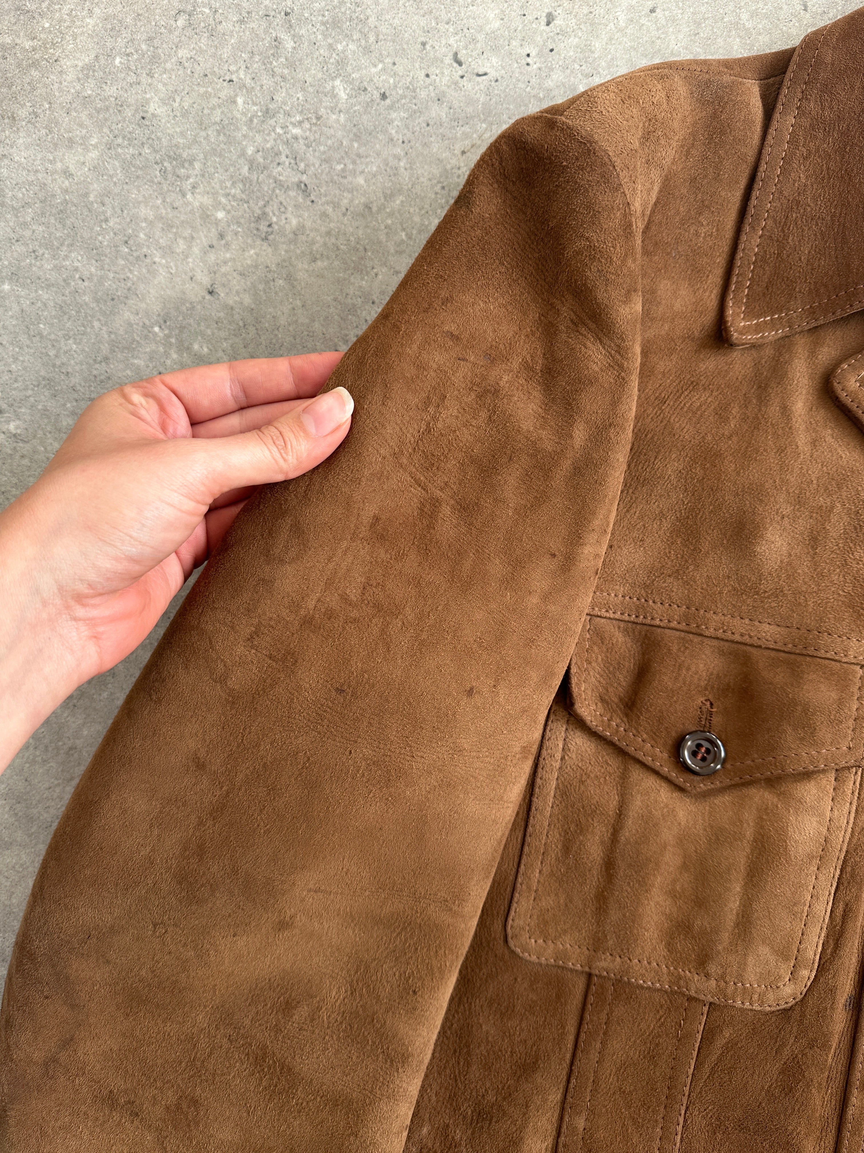 Vintage British 70s suede leather trucker jacket in size L, classic retro style with detailed stitching and collar.