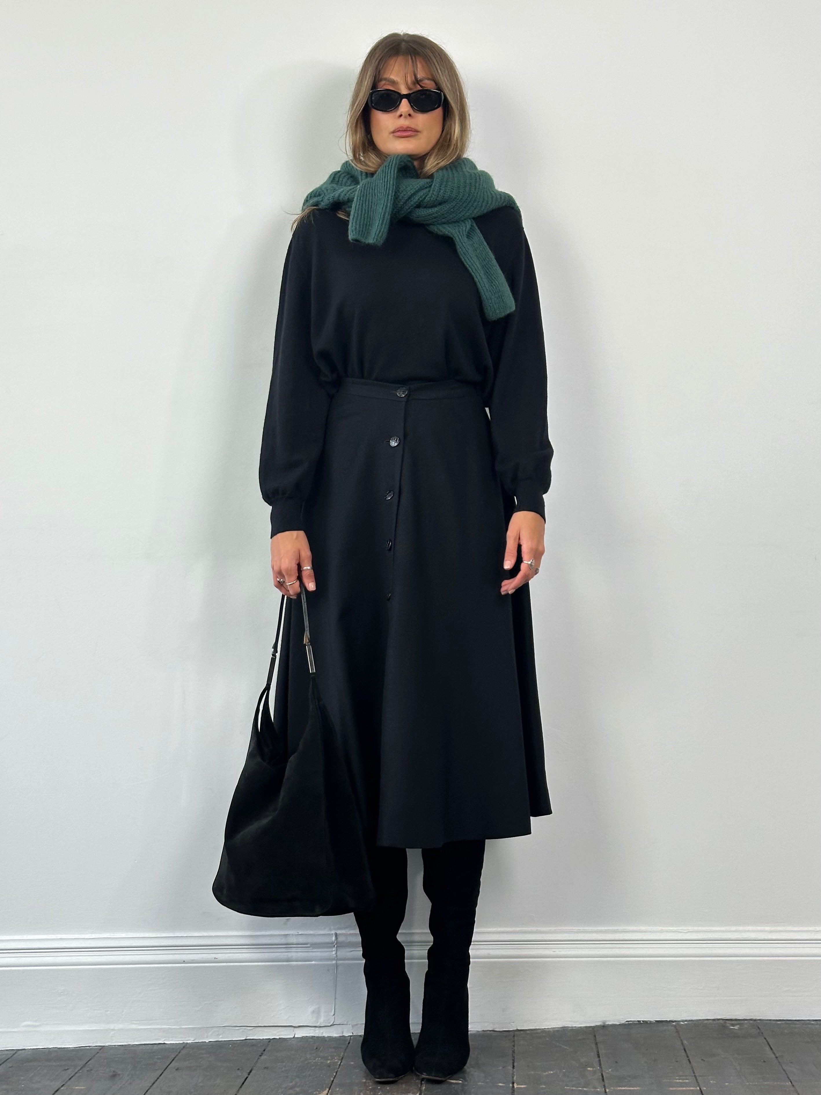 Vintage pure brushed wool A-line skirt displayed on a hanger, showcasing its classic design and textured fabric.