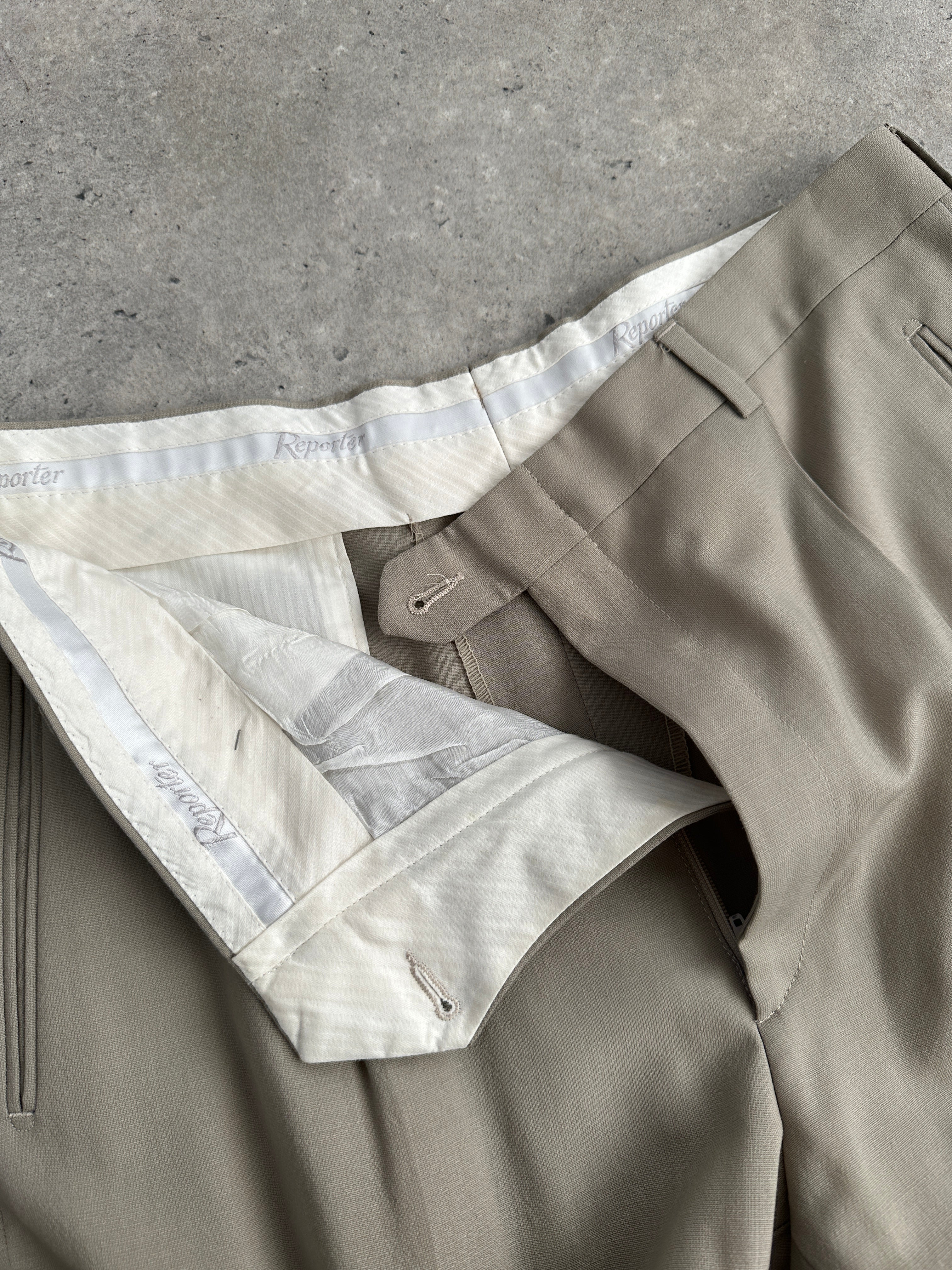 Vintage wool high-waisted straight-leg trousers with a classic fit, shown in a neutral color on a hanger.