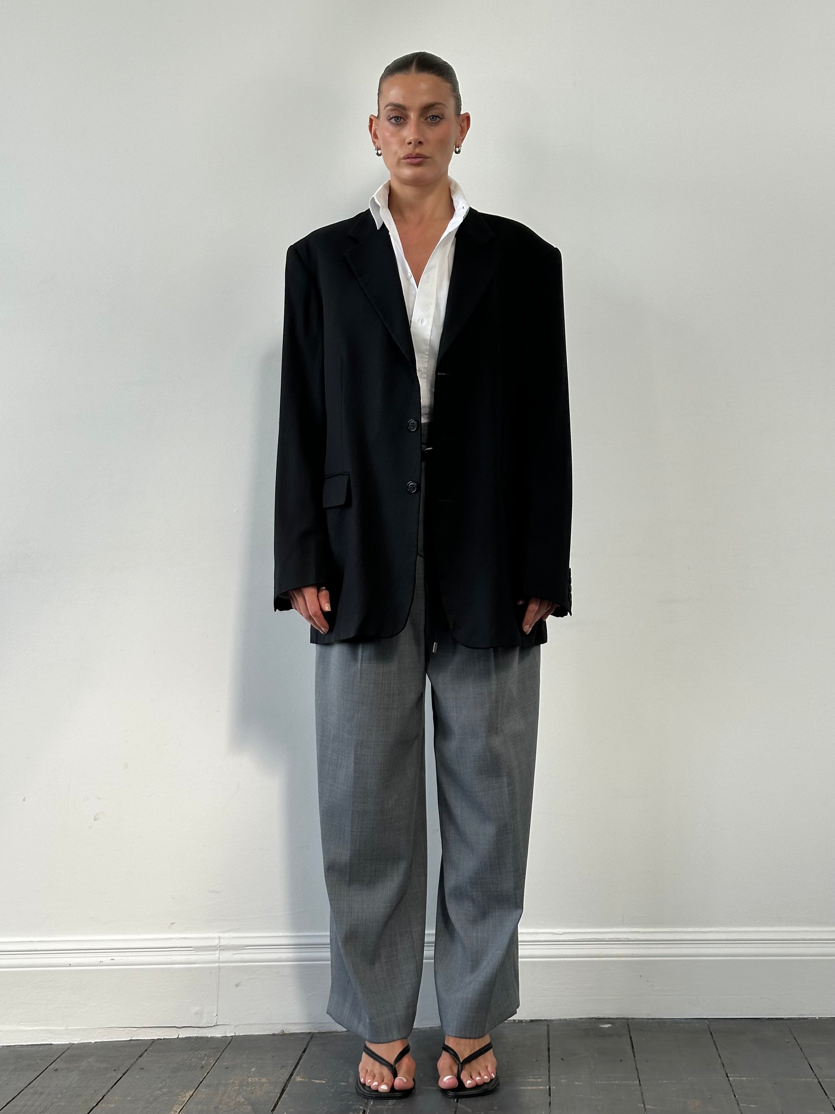 Yves Saint Laurent 1990s pure wool single-breasted blazer in size 46R/XXL, shown on a mannequin with a tailored fit and classic lapel.