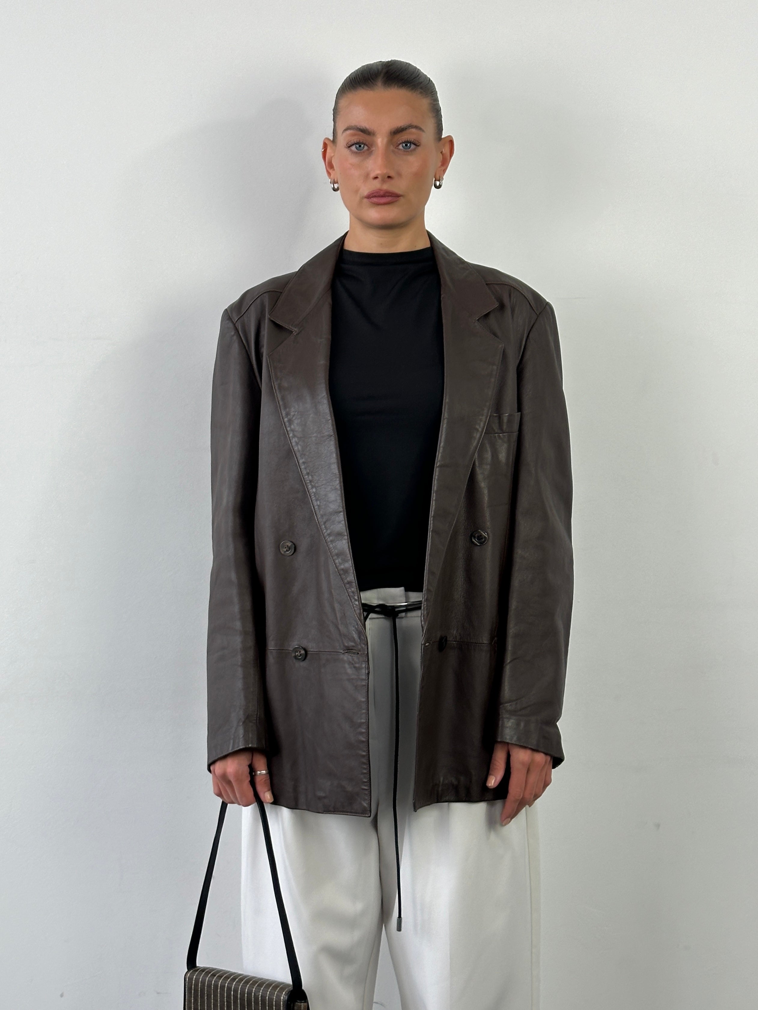 Vintage double-breasted leather blazer jacket in size large, featuring classic design and rich leather texture.