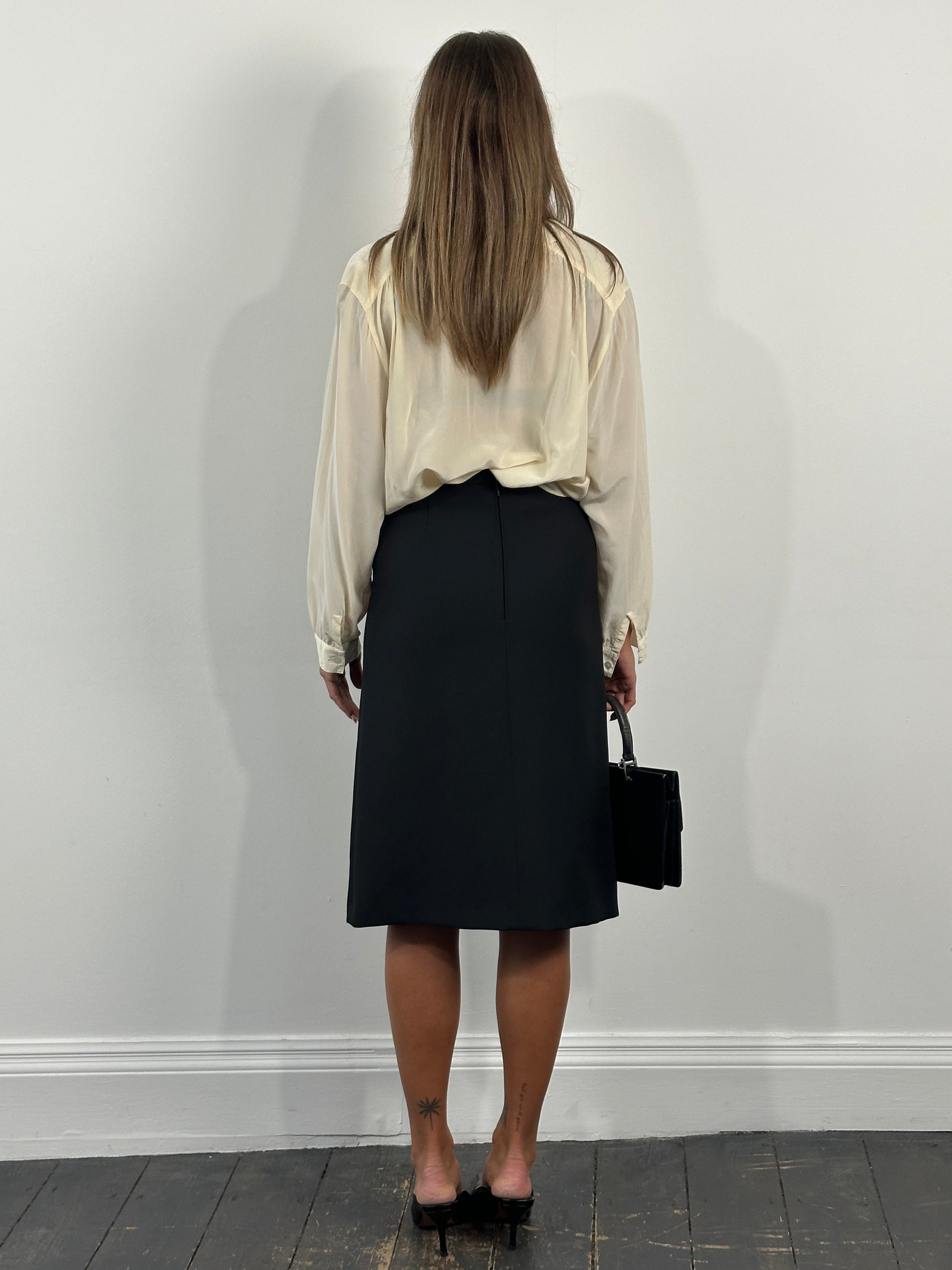Vintage 1990s A-line skirt in size W26, featuring classic denim fabric and a high-waisted design, displayed flat on a white background.