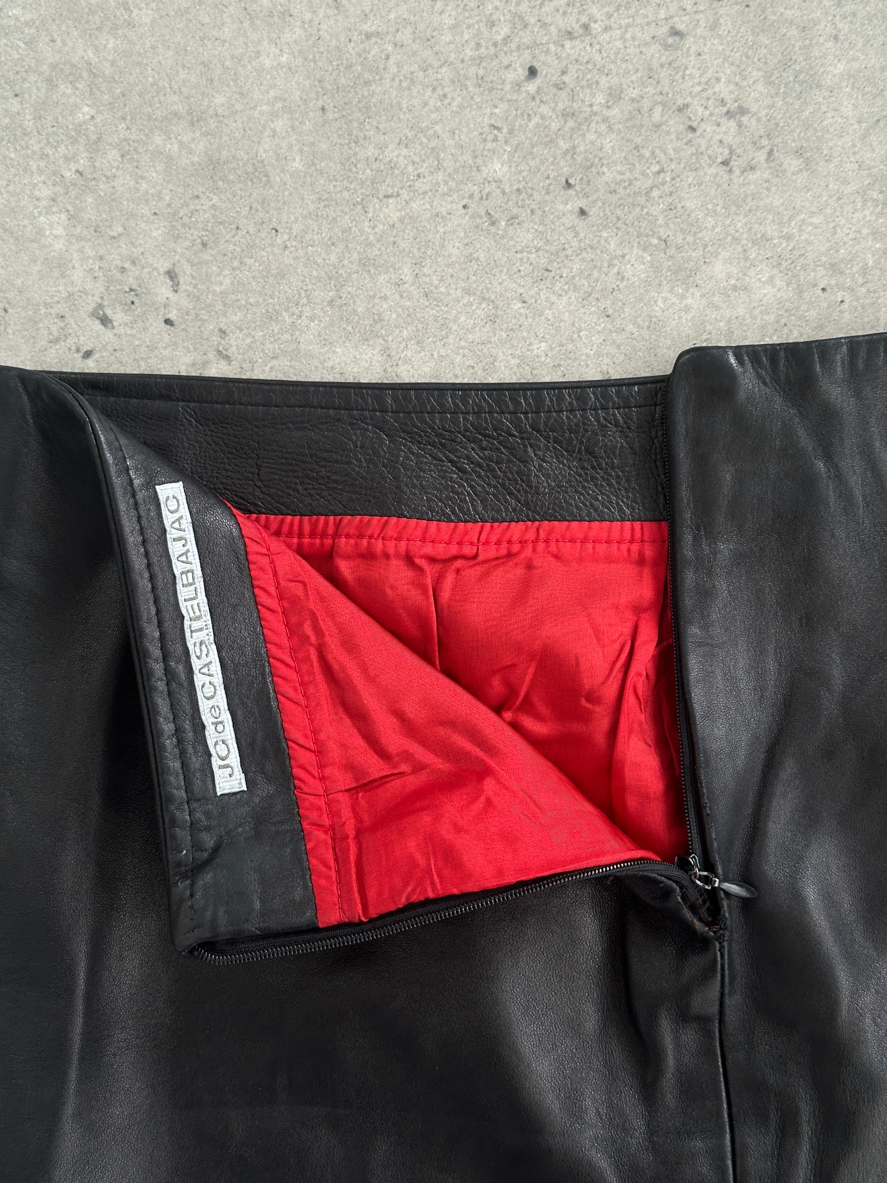 Jc de Castelbajac Paris soft leather mini skirt in black, featuring a sleek fit and stylish design, shown on a hanger.