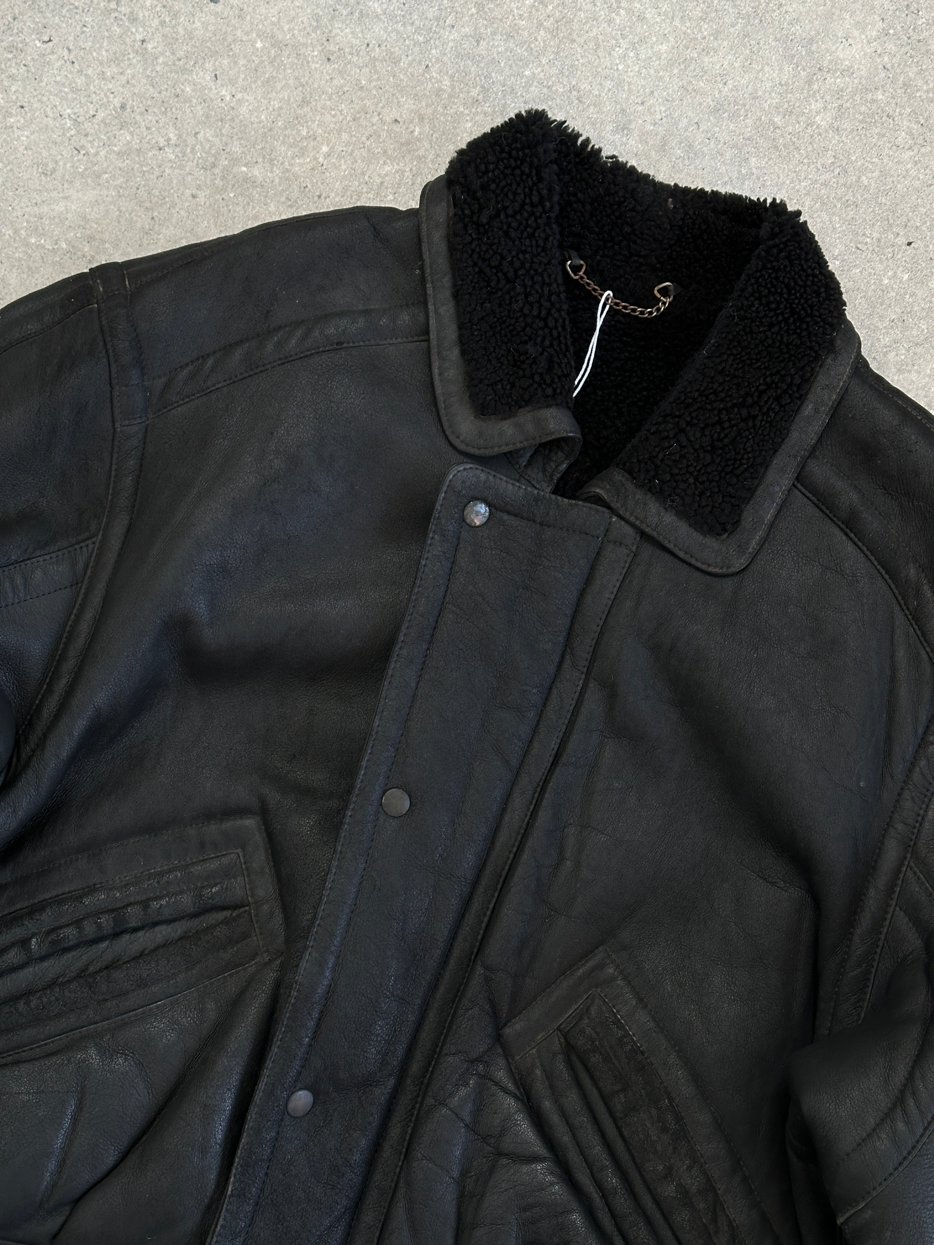 Vintage shearling leather jacket in size M/L, featuring classic design, warm shearling lining, and rugged leather exterior.