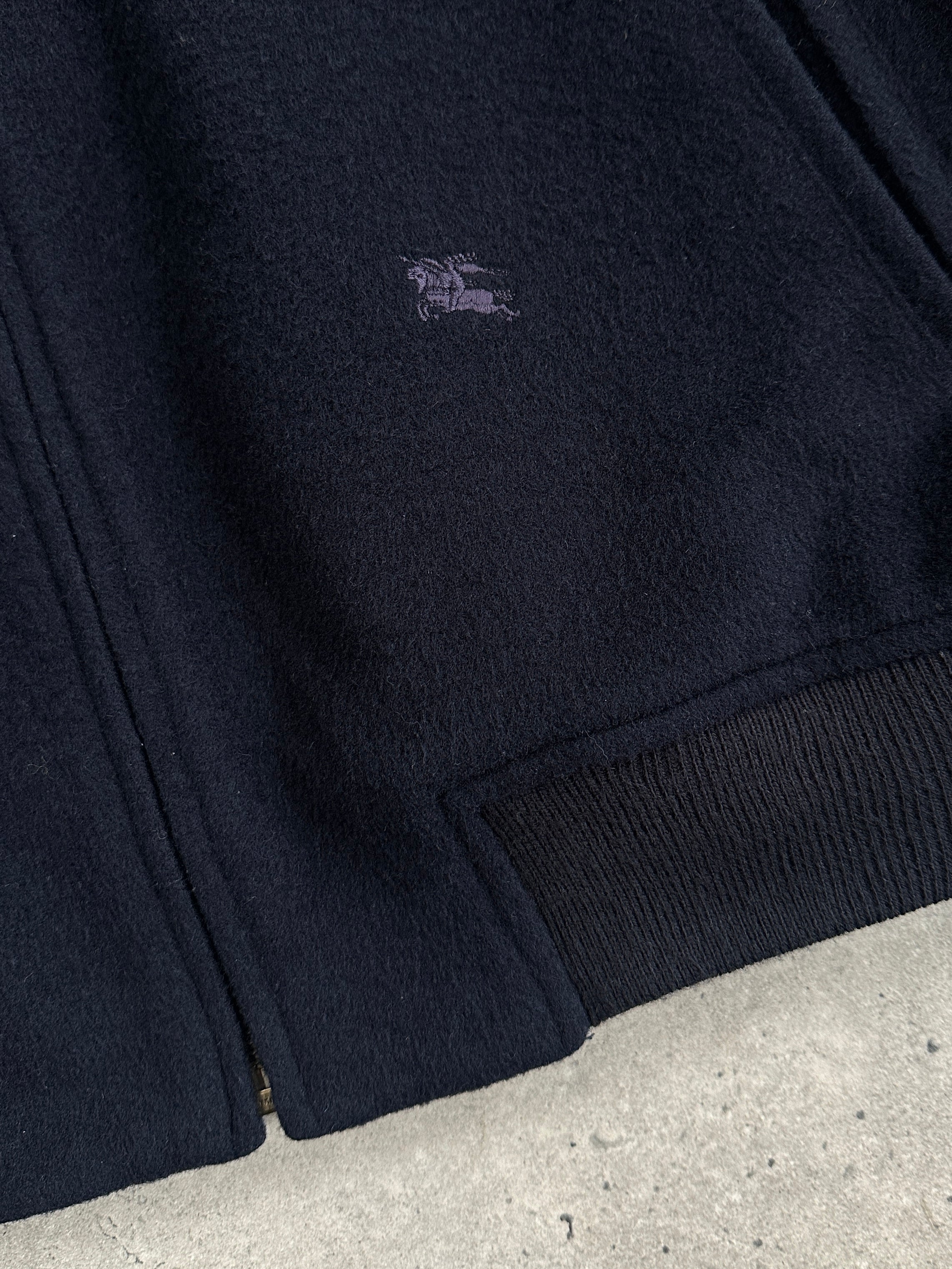 Burberry 1990s pure wool check logo bomber jacket in size L/XL, featuring classic plaid pattern and ribbed collar and cuffs.