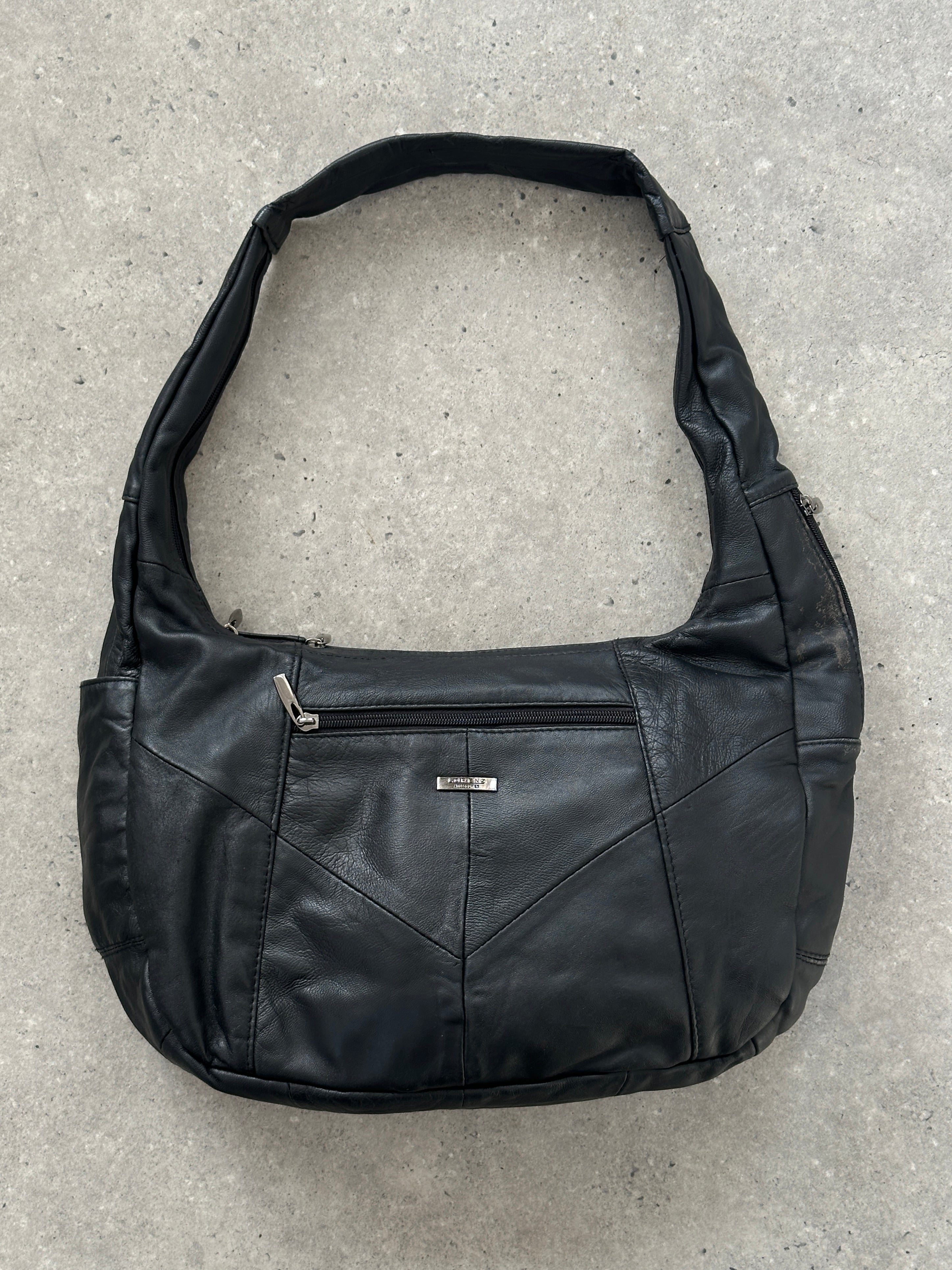 Vintage leather patchwork sling crossbody bag with adjustable strap and multiple compartments, stylish and durable for everyday use.