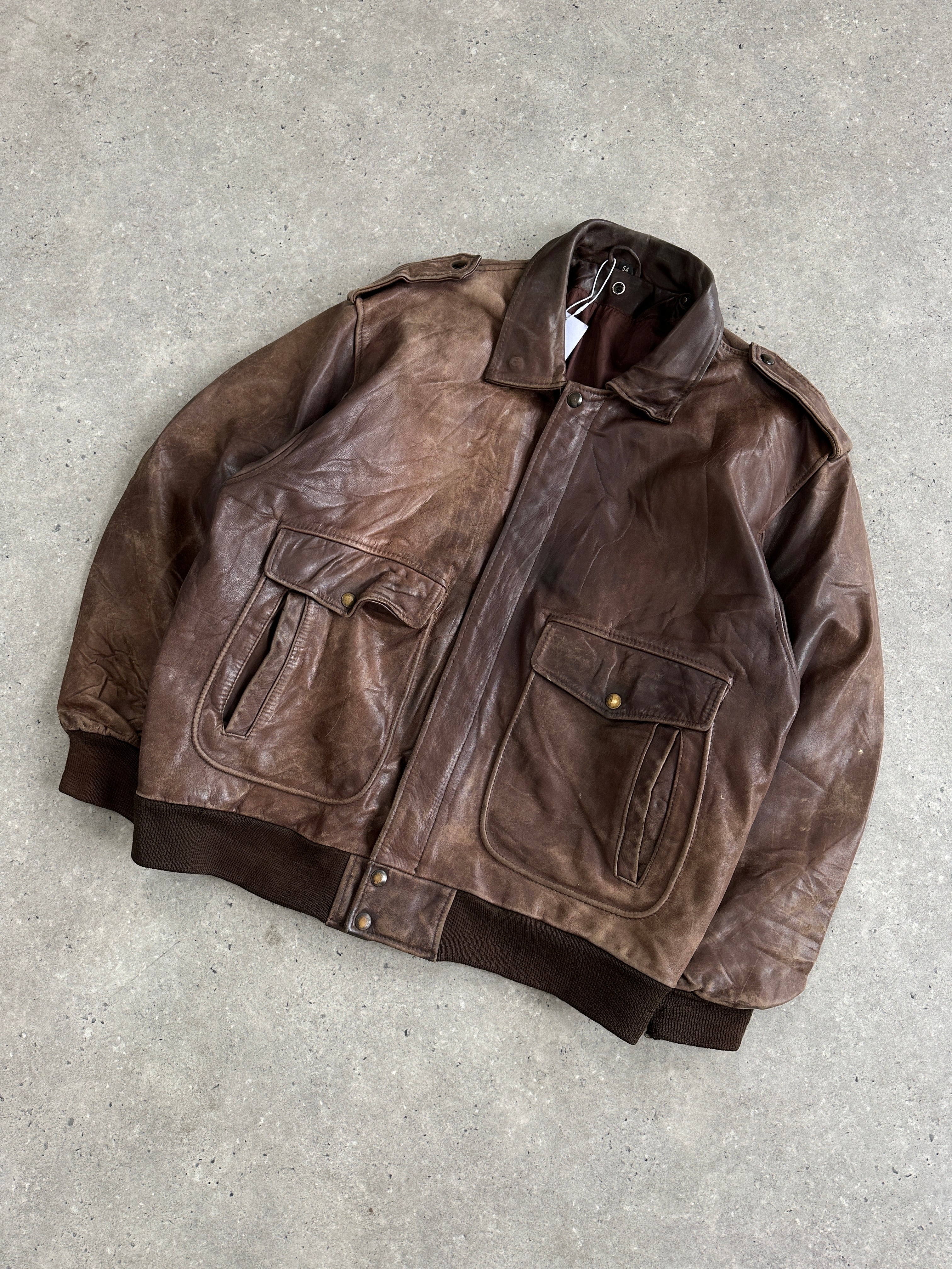 Vintage distressed leather bomber jacket in XL, featuring a rugged design and classic style, shown from the front.