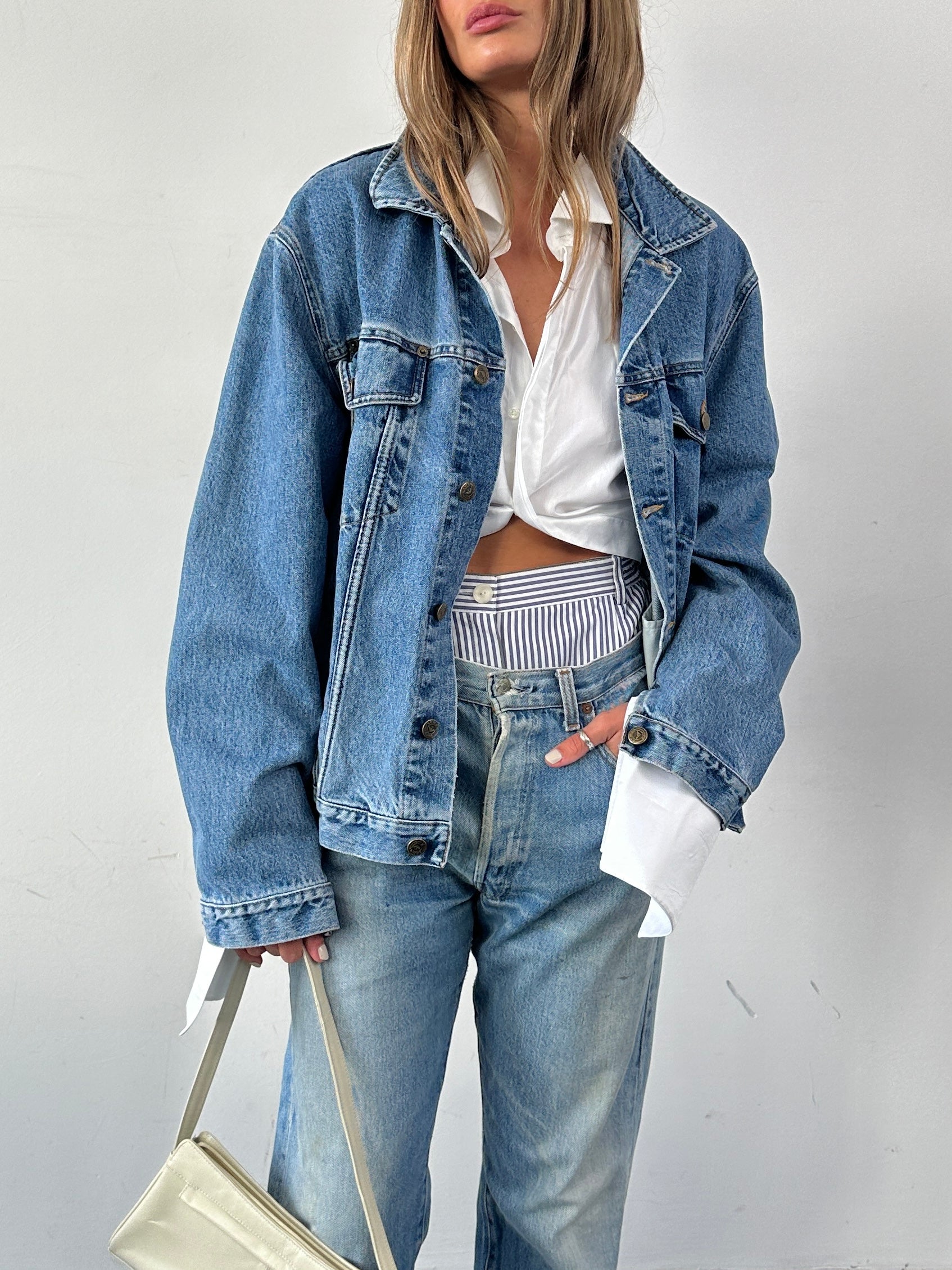 Armani Jeans mid-wash denim jacket in size L, featuring classic design with front pockets and button closures.