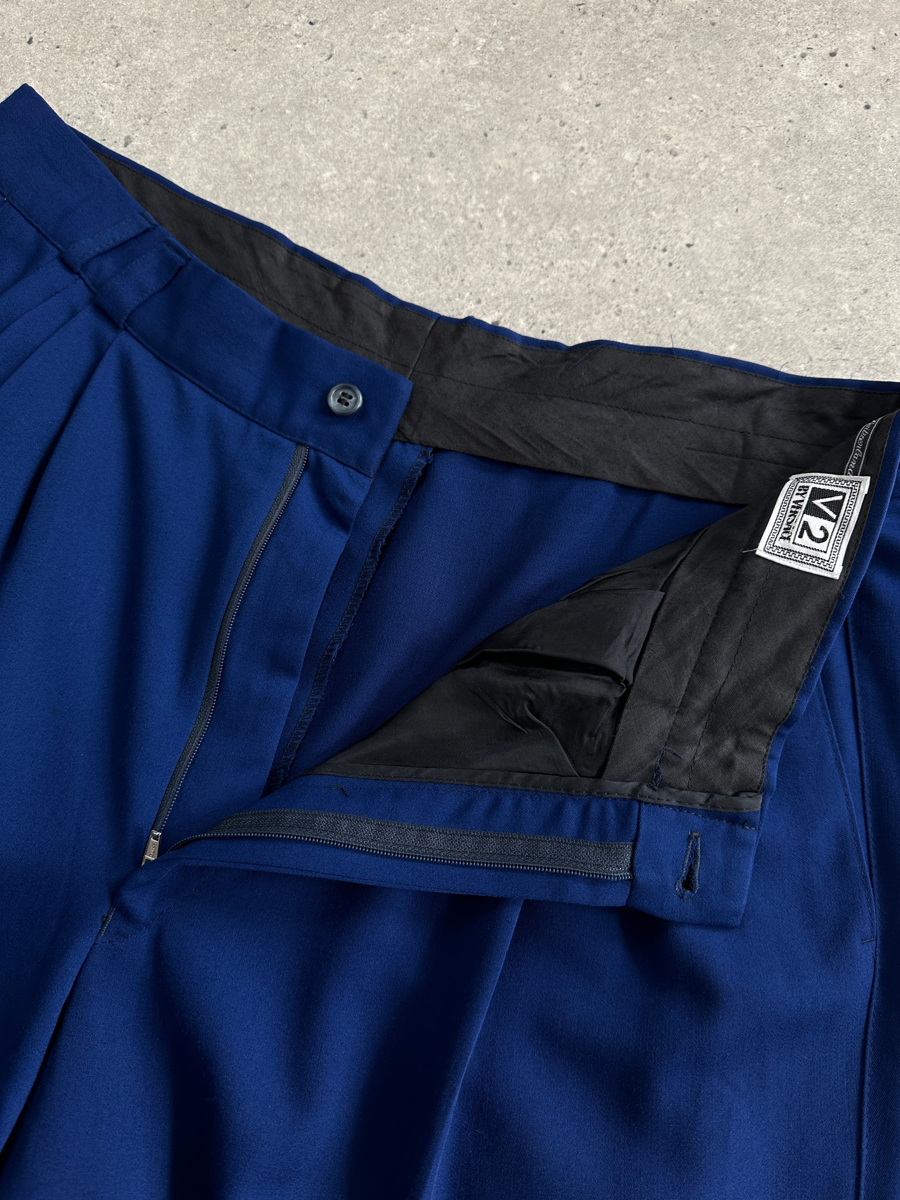 Versace Classic V2 wool pleated high-waisted tailored trousers in dark fabric, front view showing pleats and tailored fit.