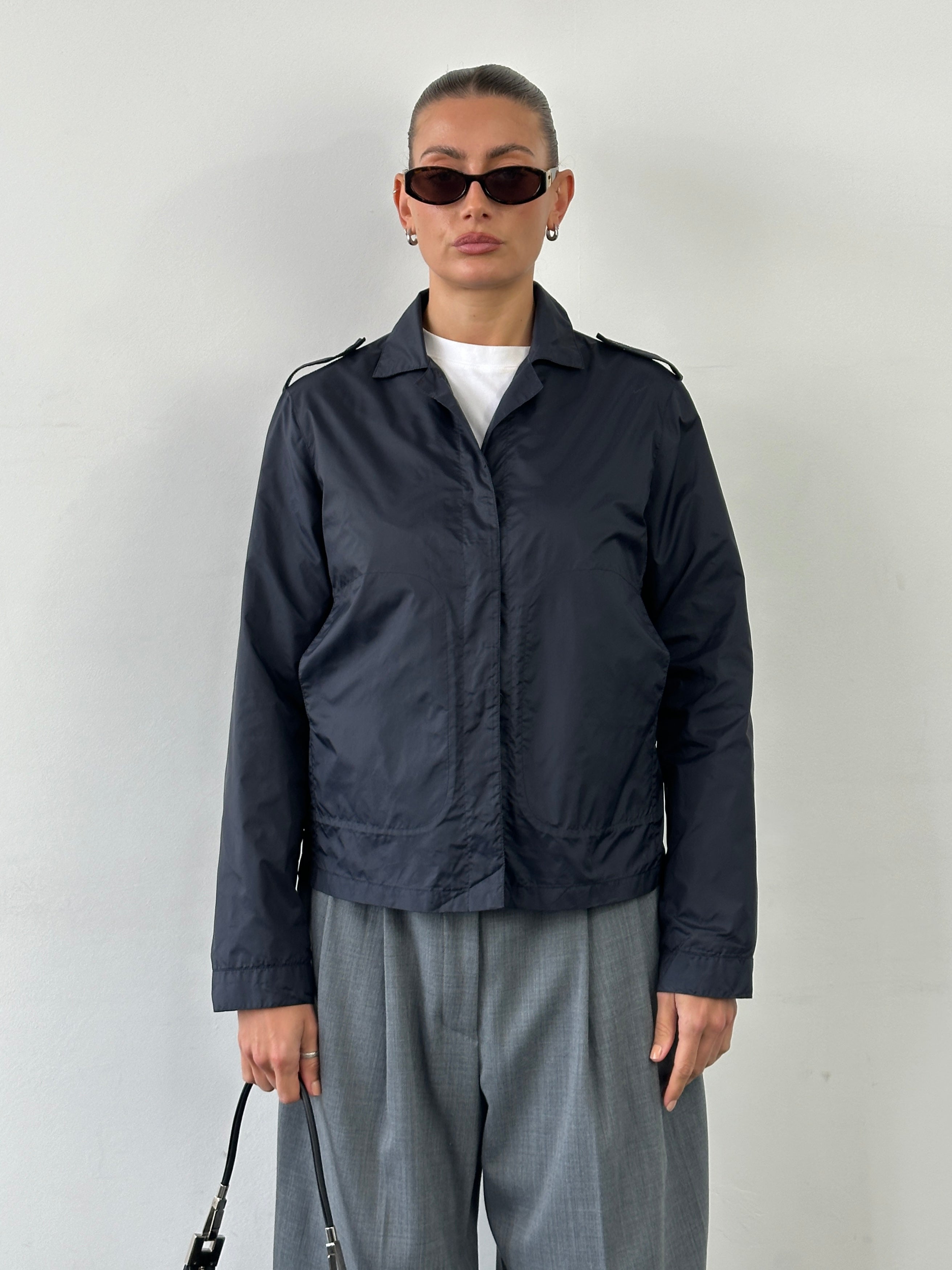 Armani Jeans 1990s showerproof nylon lightweight logo jacket in black, S/M, with subtle branding and sleek design details.