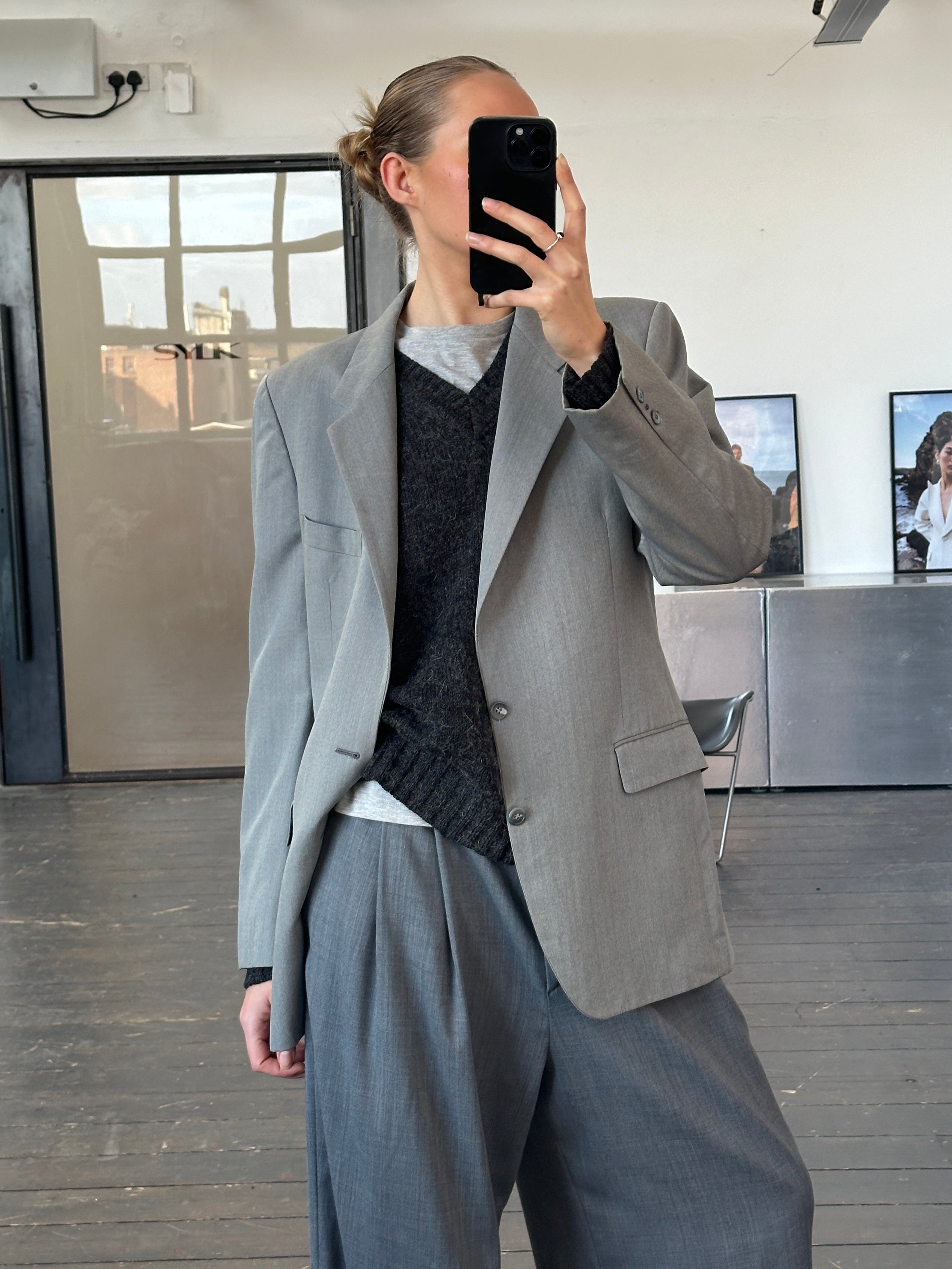 Yves Saint Laurent 1990s pure wool single-breasted blazer in size 40R/L, tailored fit, dark classic color, and structured design.
