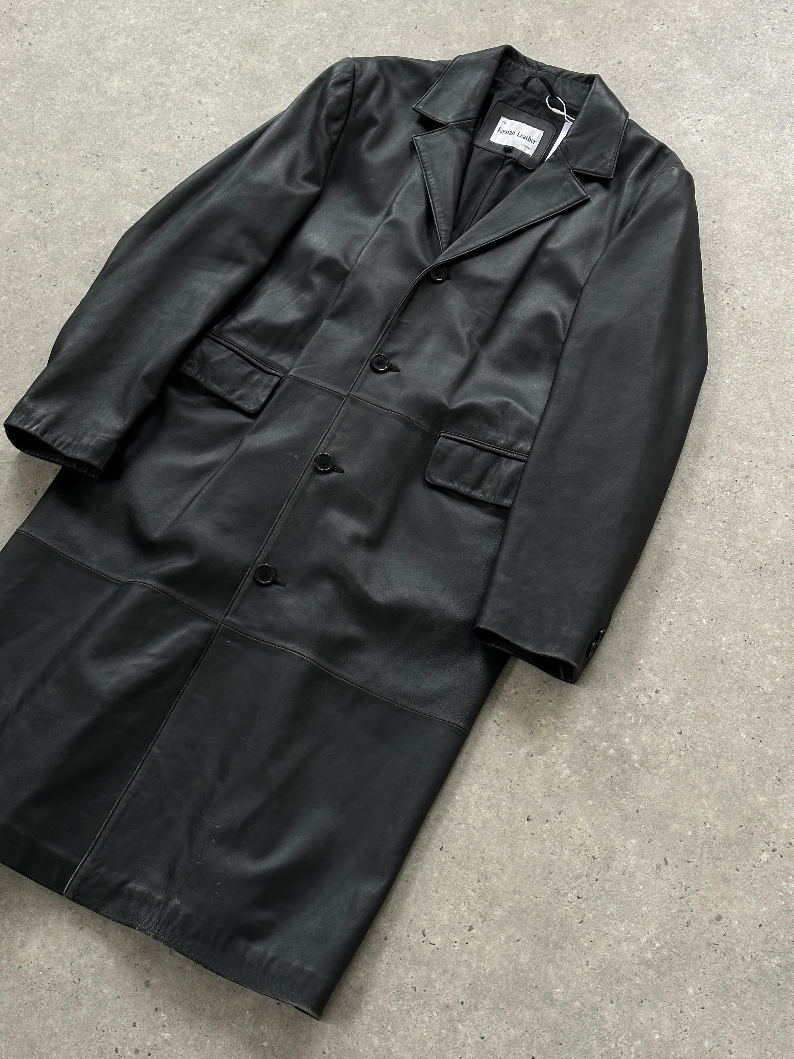 Vintage leather trench coat in size XL, showing classic design with a tailored fit and aged leather texture.