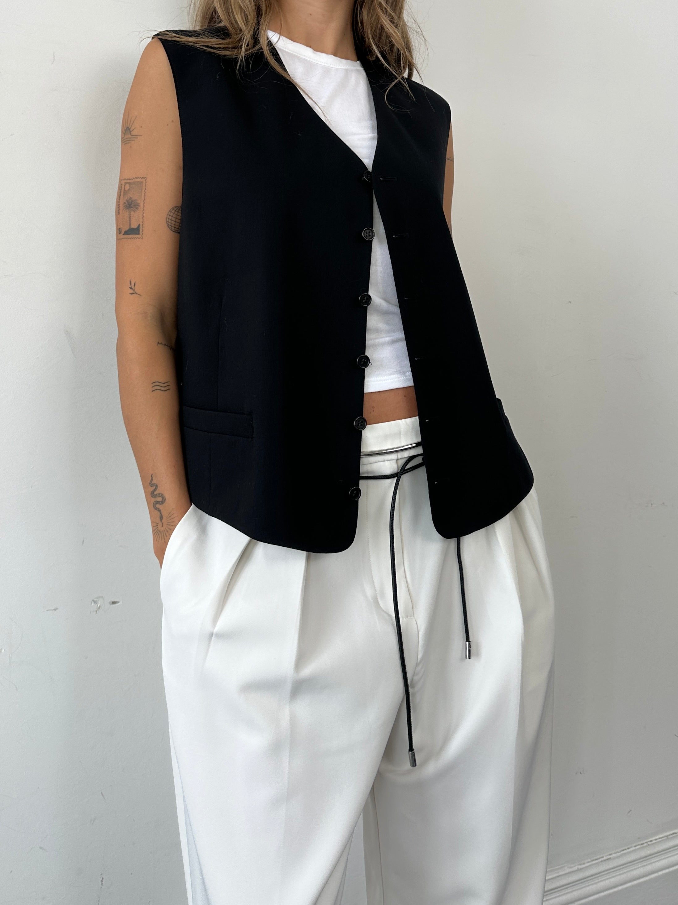 Yves Saint Laurent pure wool tailored waistcoat in size 46R/XL, shown on a hanger with a classic design and neutral color.