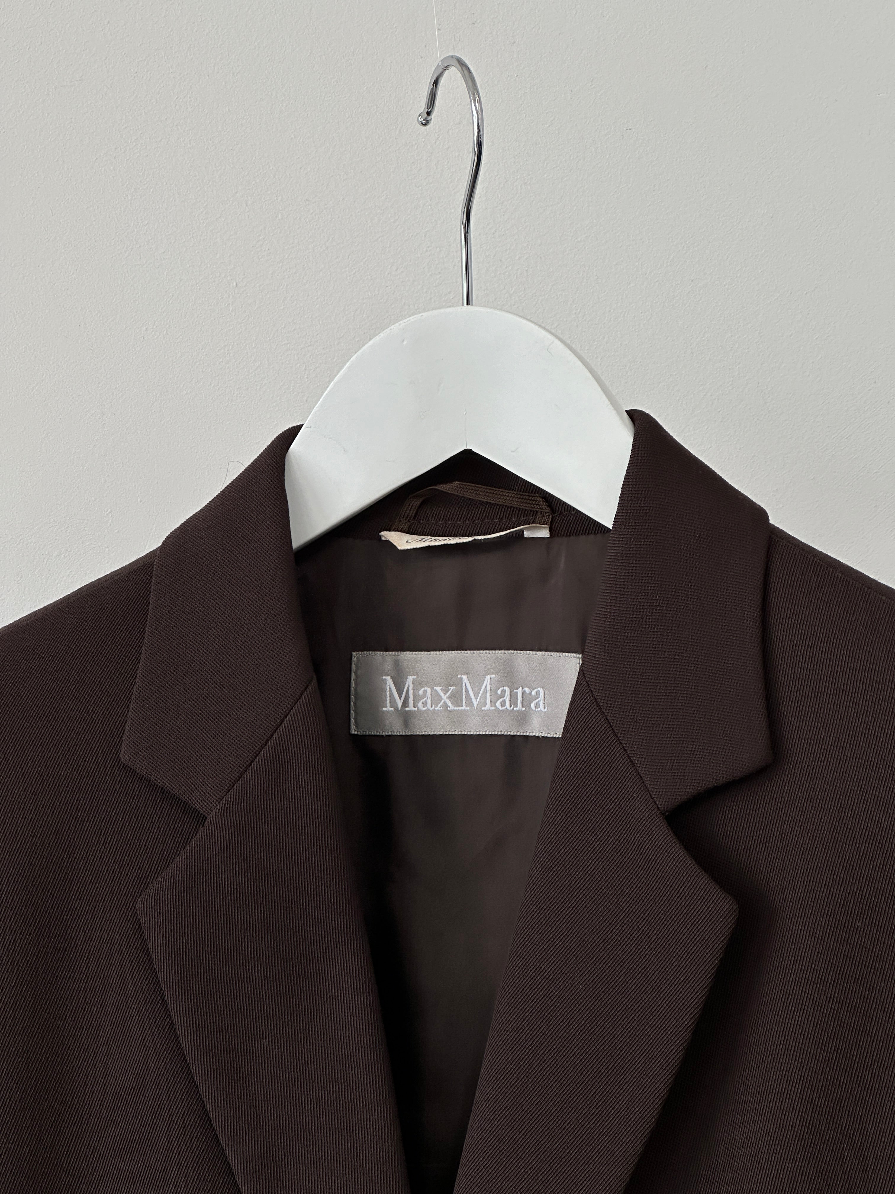 Max Mara virgin wool single-breasted blazer in size M, tailored fit with classic lapel and button closure, shown on a hanger.