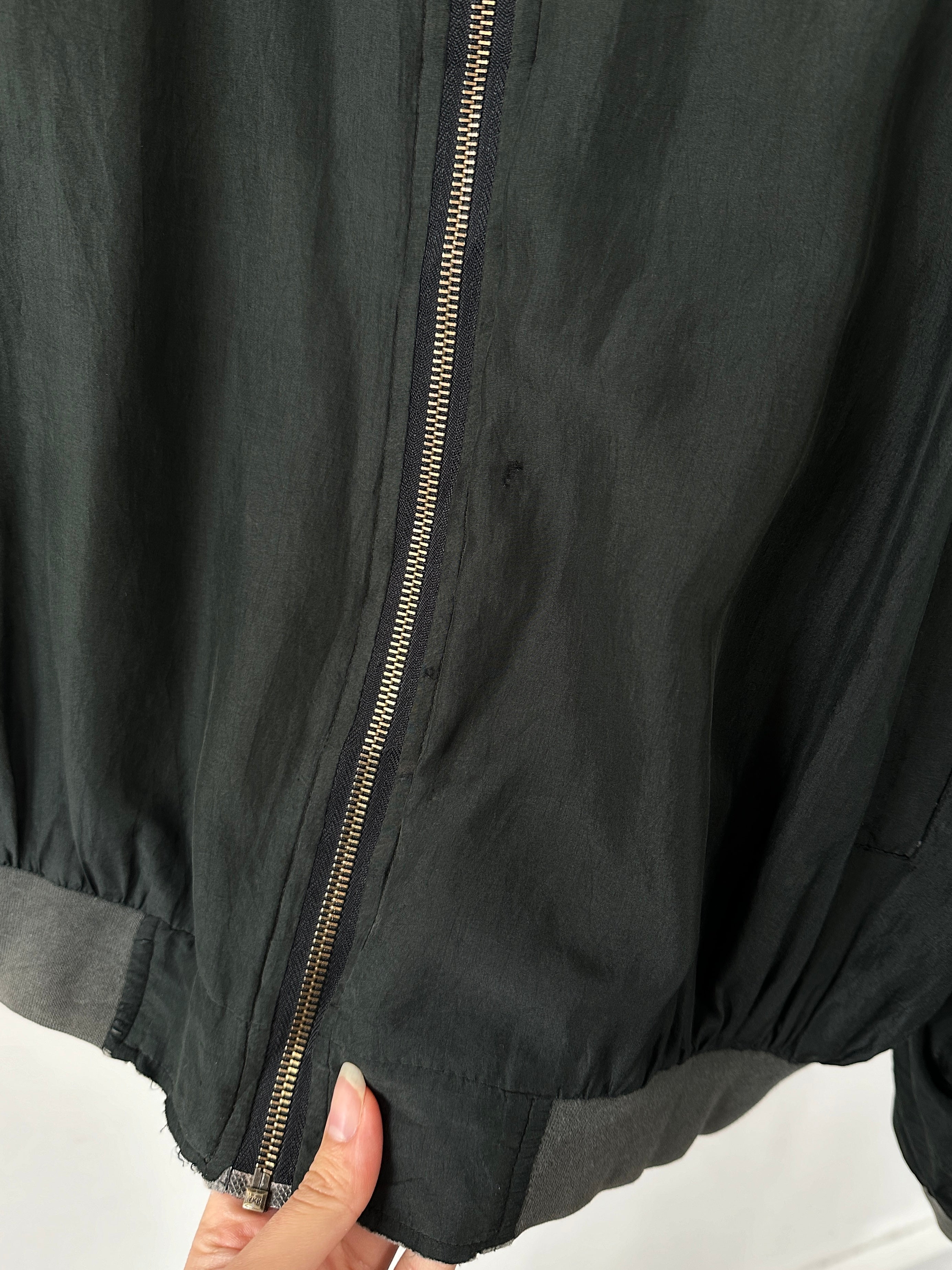 Vintage pure silk bomber jacket in size L, featuring a classic design with a smooth, shiny silk fabric and ribbed cuffs.
