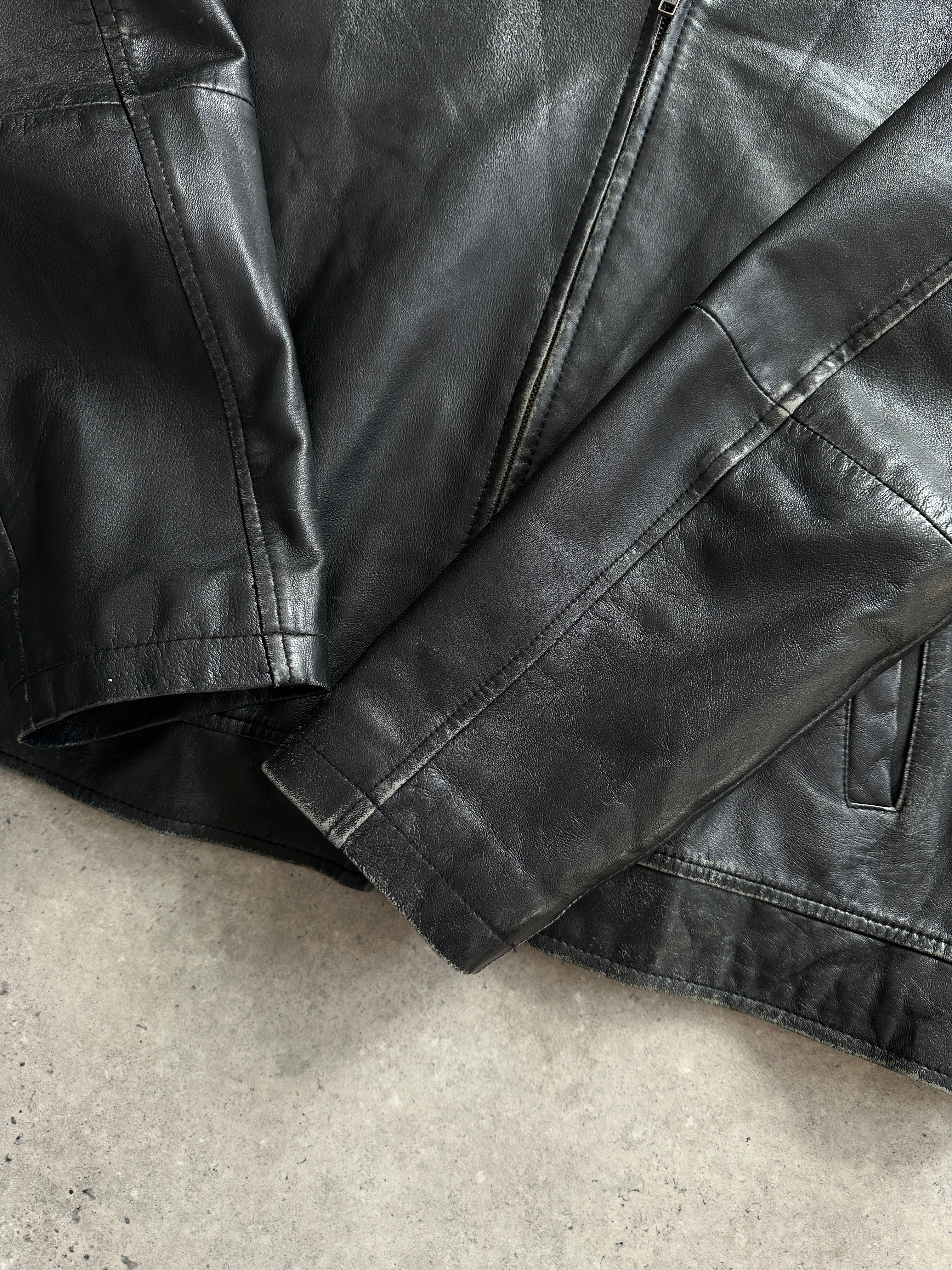 Conbipel minimal leather jacket in size L, featuring sleek design and smooth leather material, displayed on a hanger.