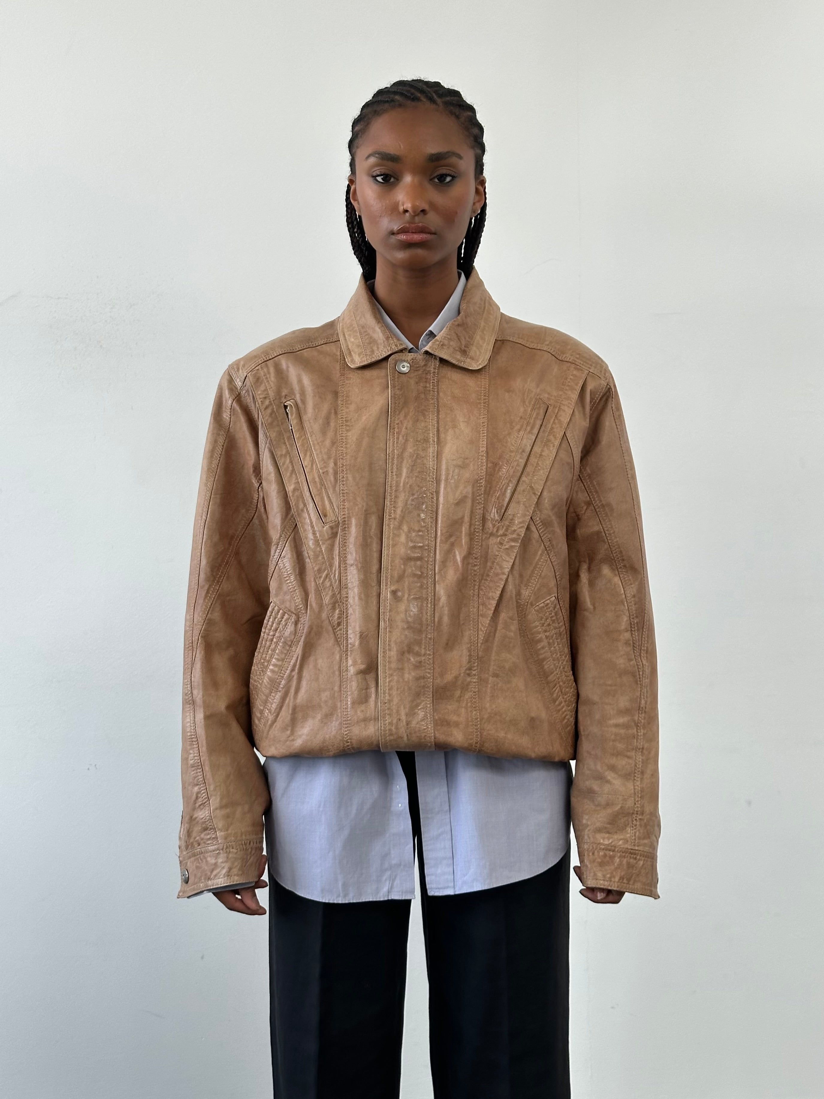 Vintage 1990s leather bomber jacket in size large, featuring classic design and authentic distressed leather from the Vintage brand.