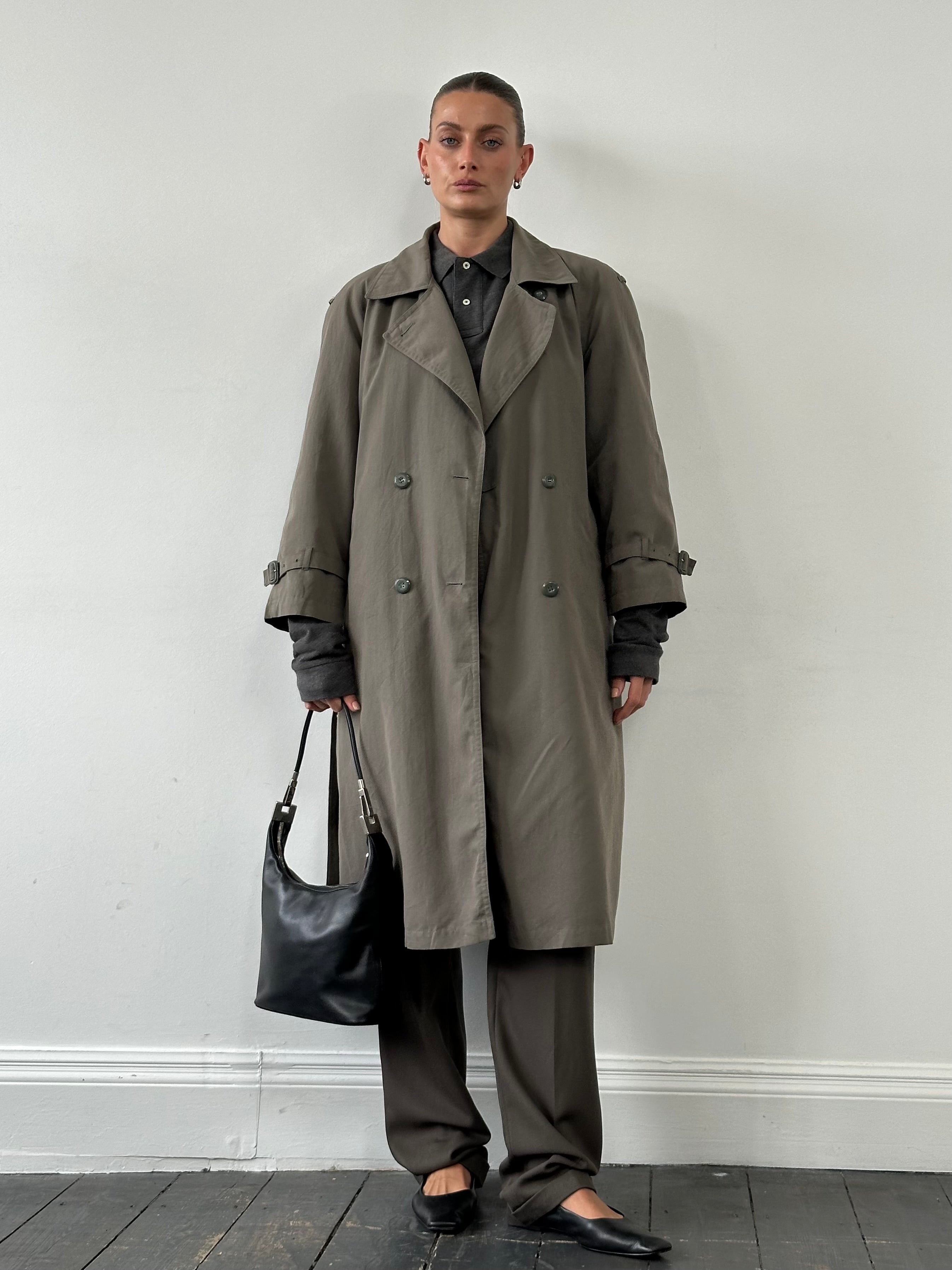 London Fog double-breasted trench coat in classic beige, tailored fit, with belt and storm flaps for a stylish, timeless look.