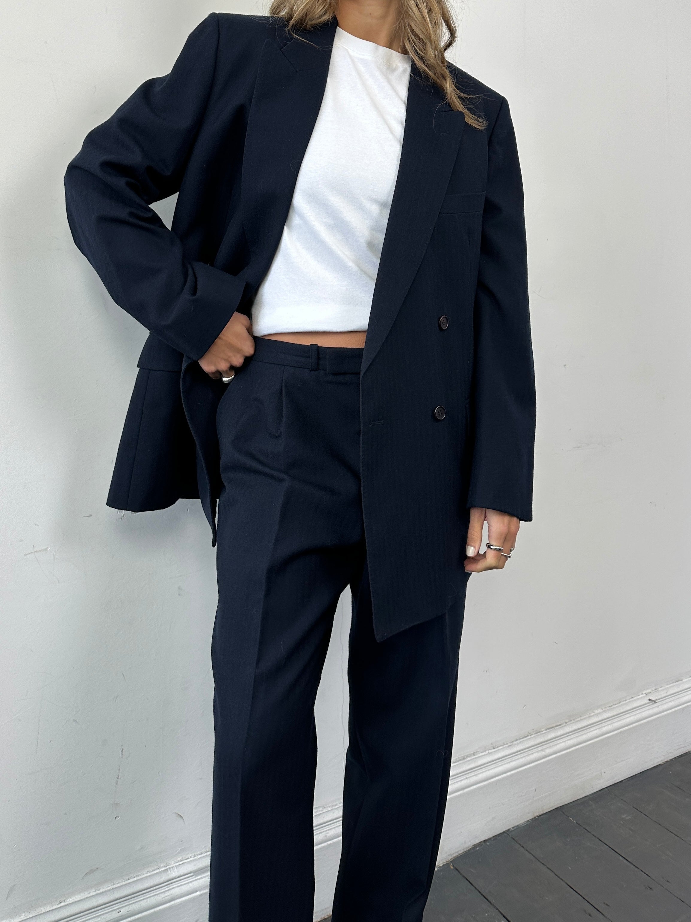 Christian Dior pure wool double-breasted jumpsuit in size 43R/W32, tailored fit, shown on a mannequin with lapel details.