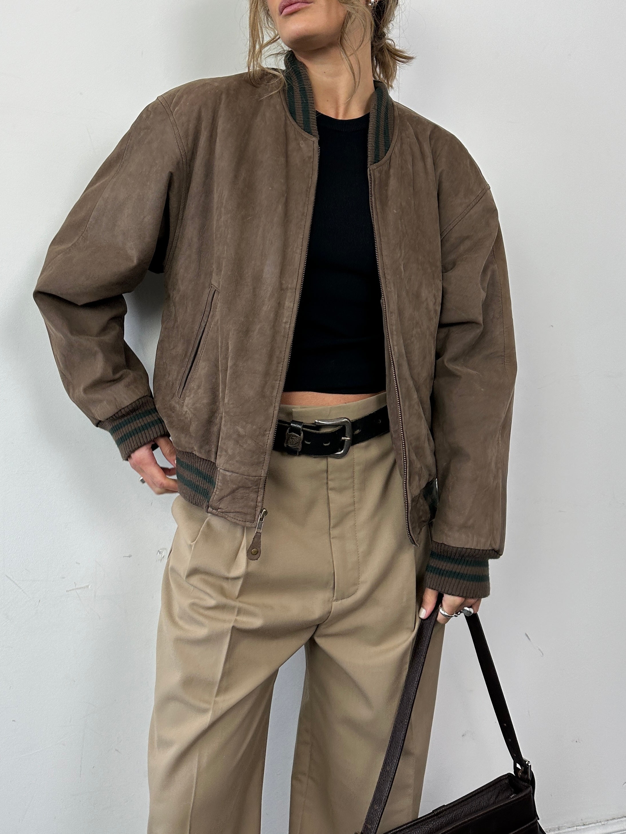 Vintage varsity nubuck leather bomber jacket in M/L size with classic design and ribbed cuffs, front zipper, and suede finish.