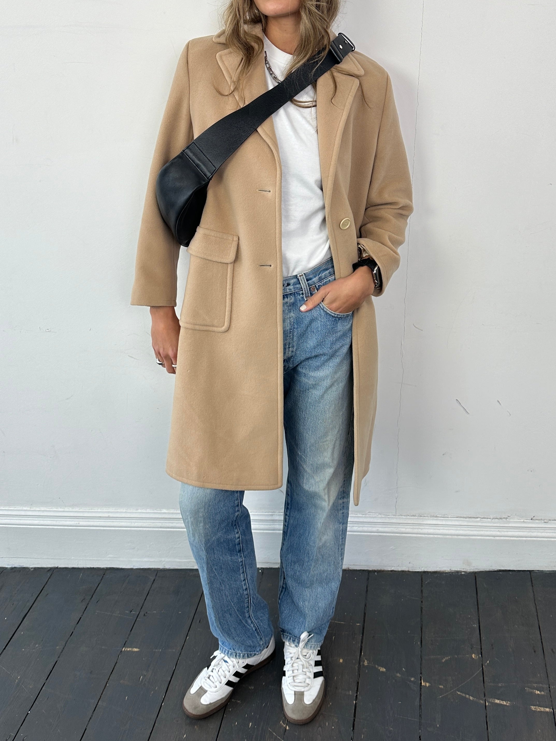 Hugo Boss pure wool single-breasted coat in size S, shown on a hanger, with a tailored fit and classic design.