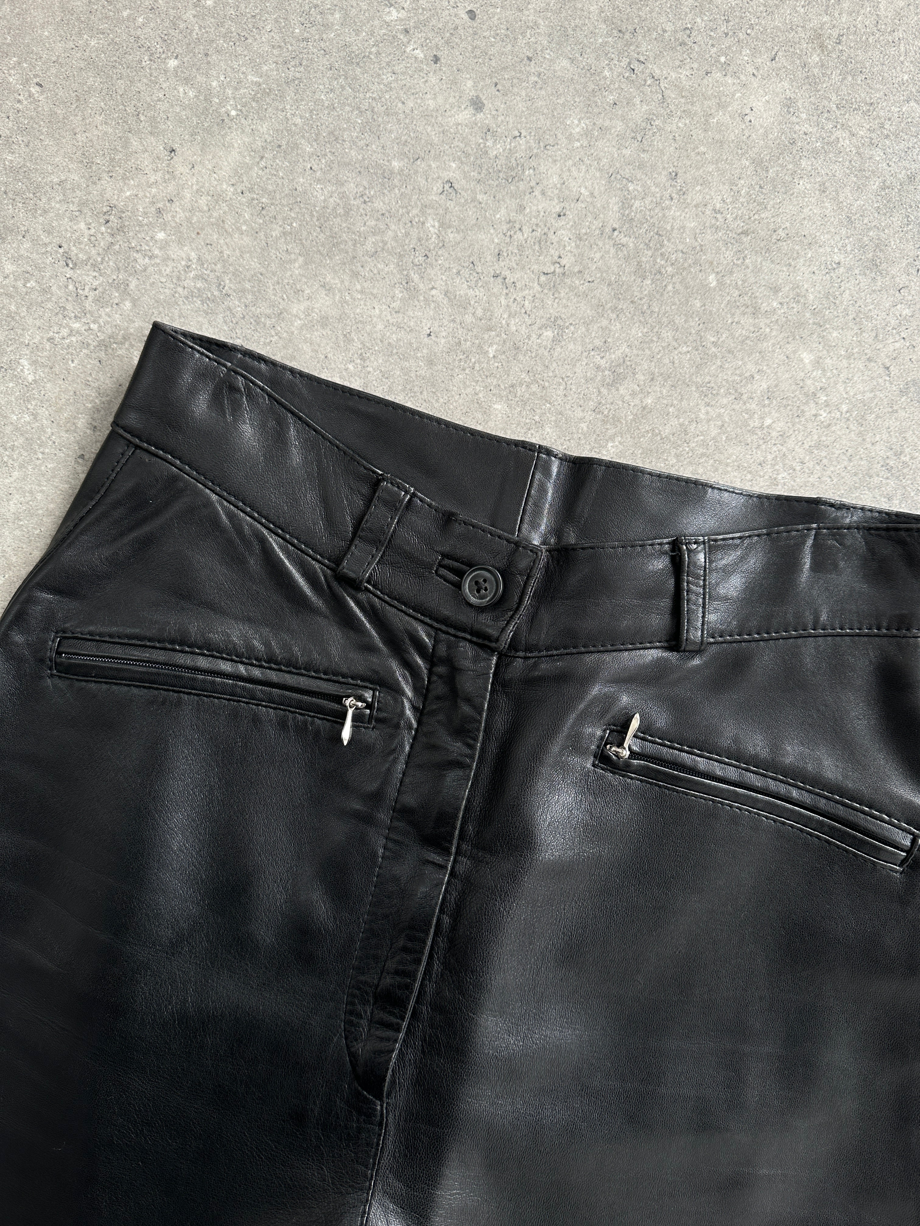 Vintage high waisted smooth leather trousers in black, featuring a classic fit with a sleek, polished appearance.