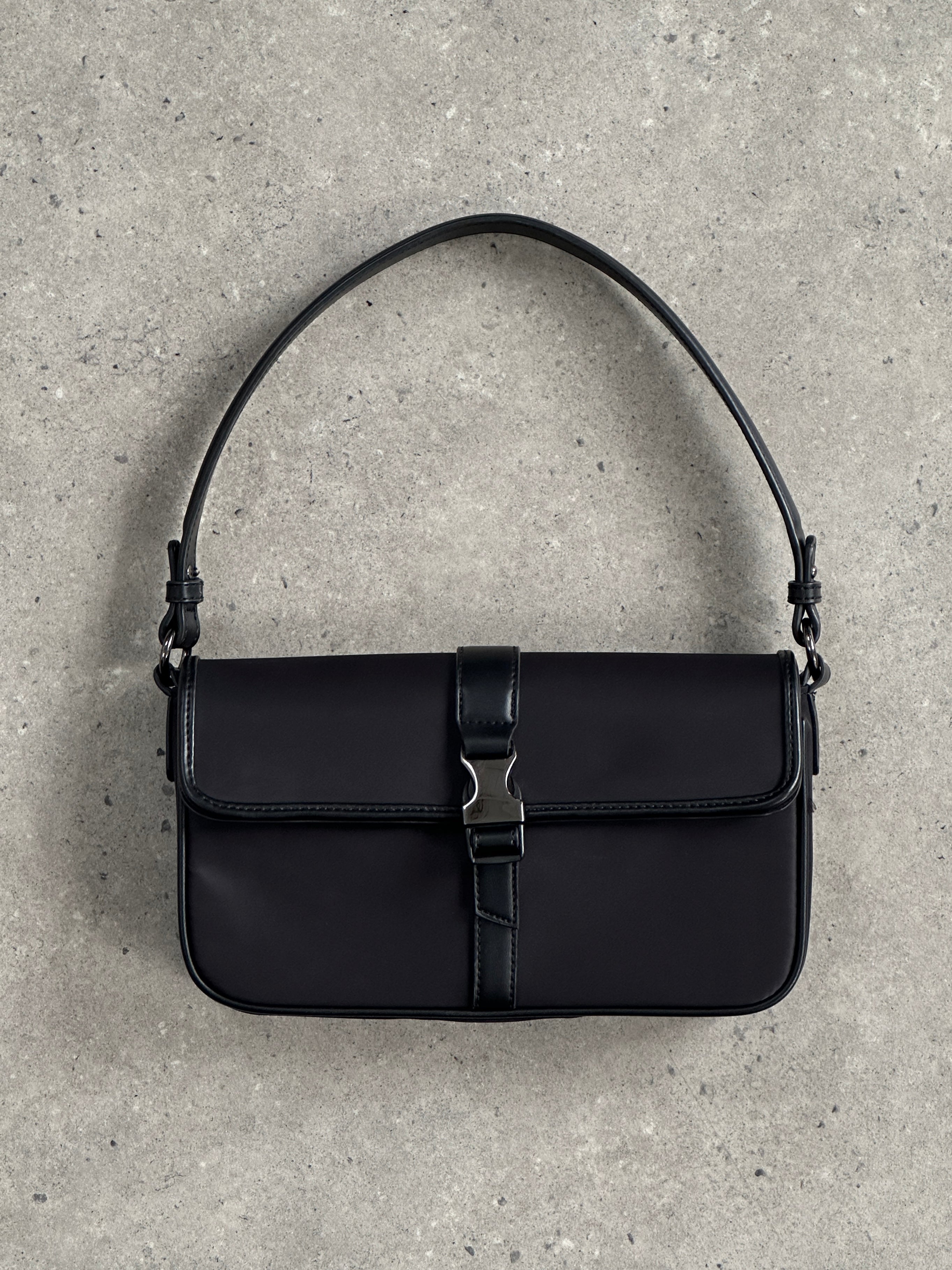 Pierre Cardin nylon hardware shoulder bag showing adjustable strap, front zipper pocket, and sleek design.