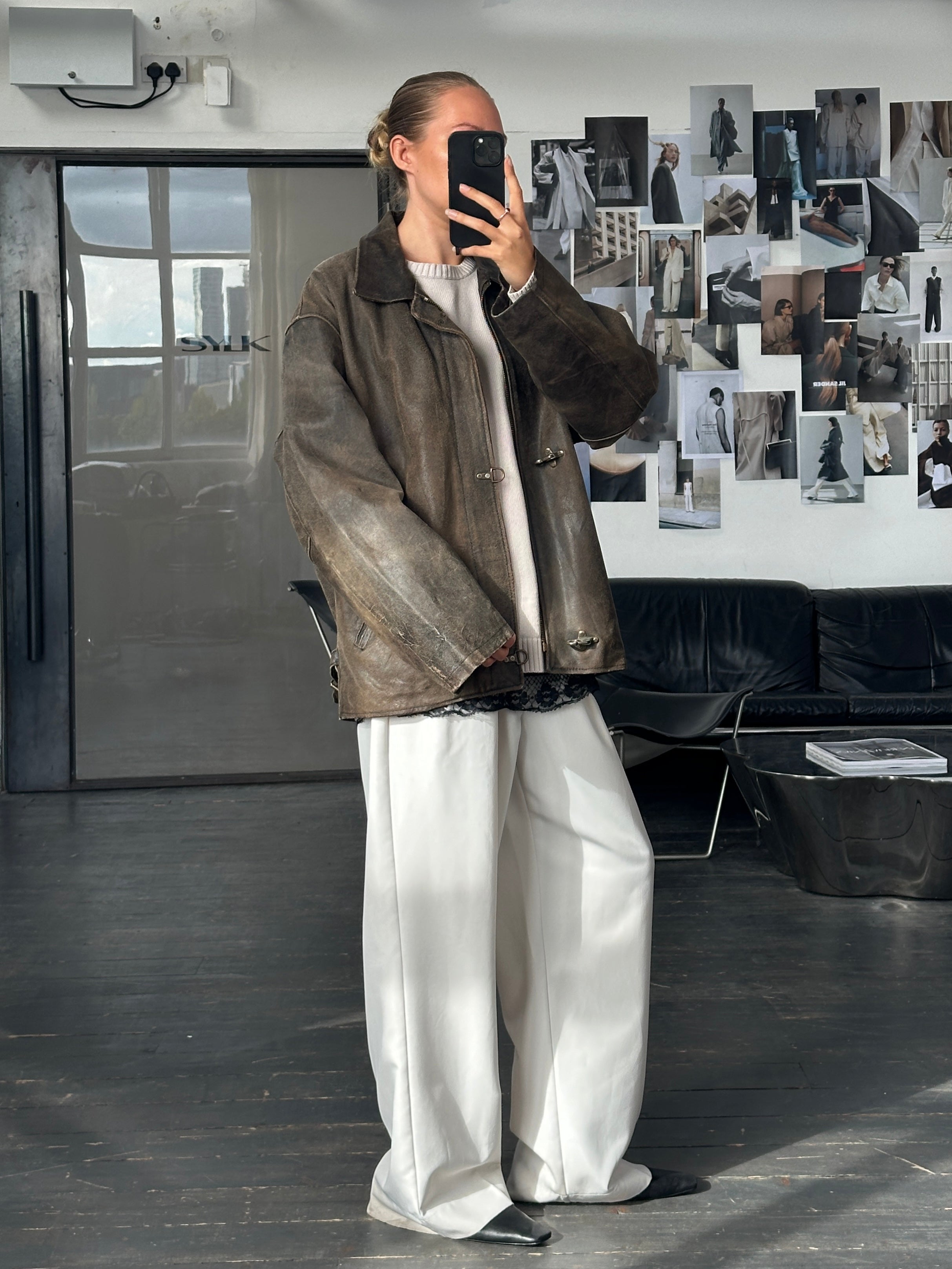 Vintage 1980s distressed leather jacket in XL, showing worn-in texture and classic style with rugged details.