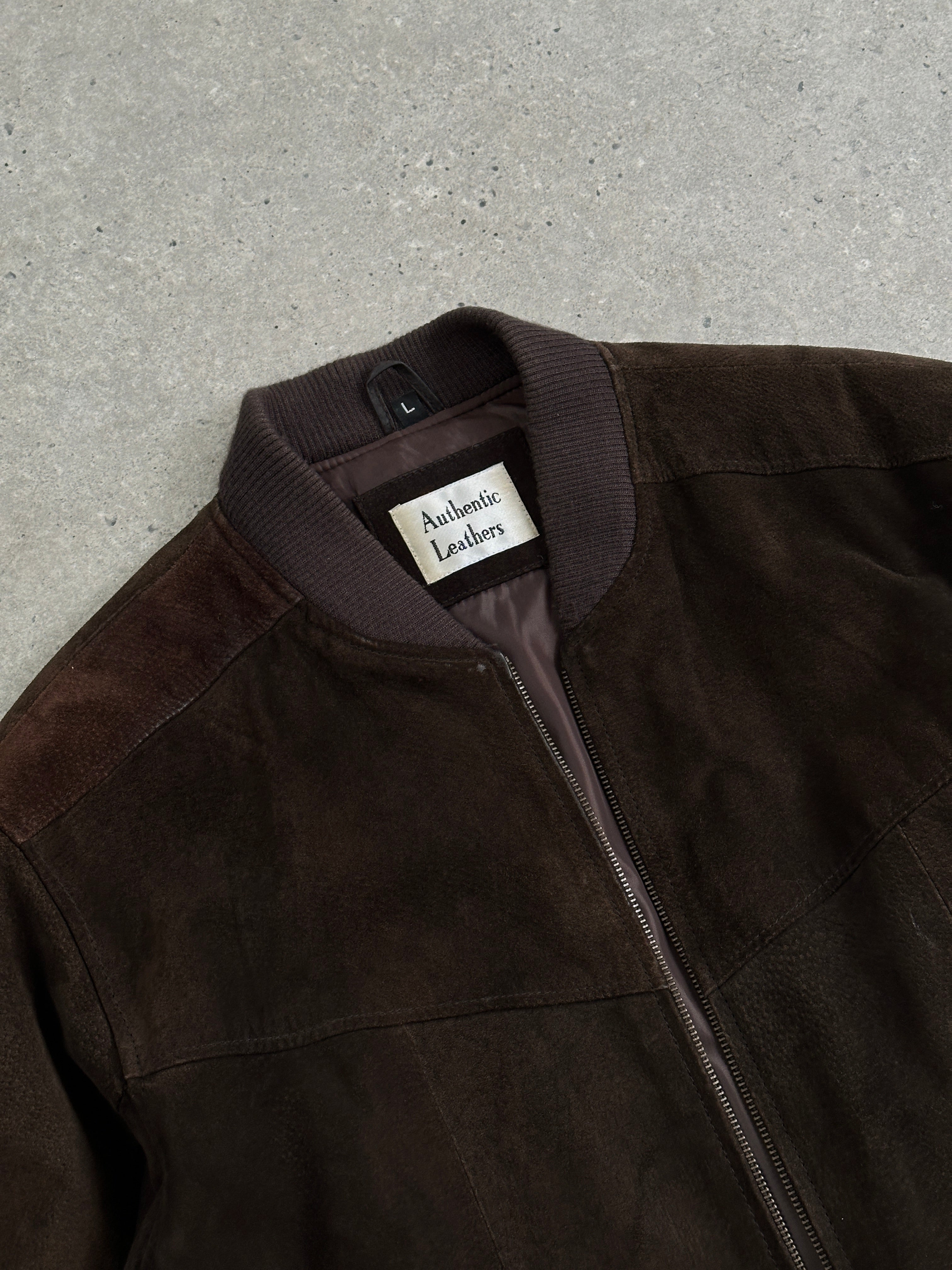 Vintage leather bomber jacket in tan suede, size large, with classic collar and ribbed cuffs, stylish and timeless outerwear.