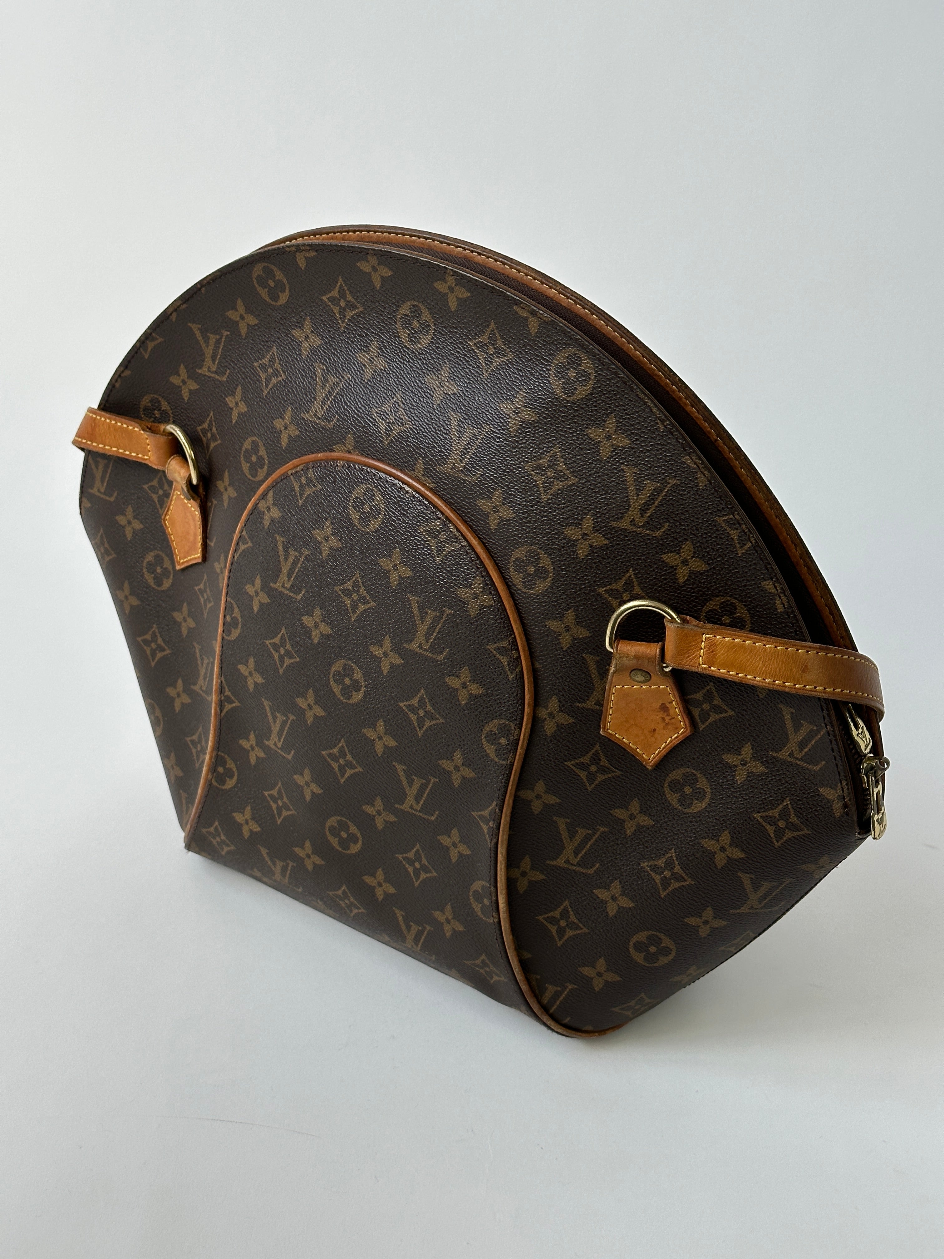 Louis Vuitton 1997 Ellipse Shoulder Bag with leather strap and monogram canvas, stylish accessory for everyday or special occasions.