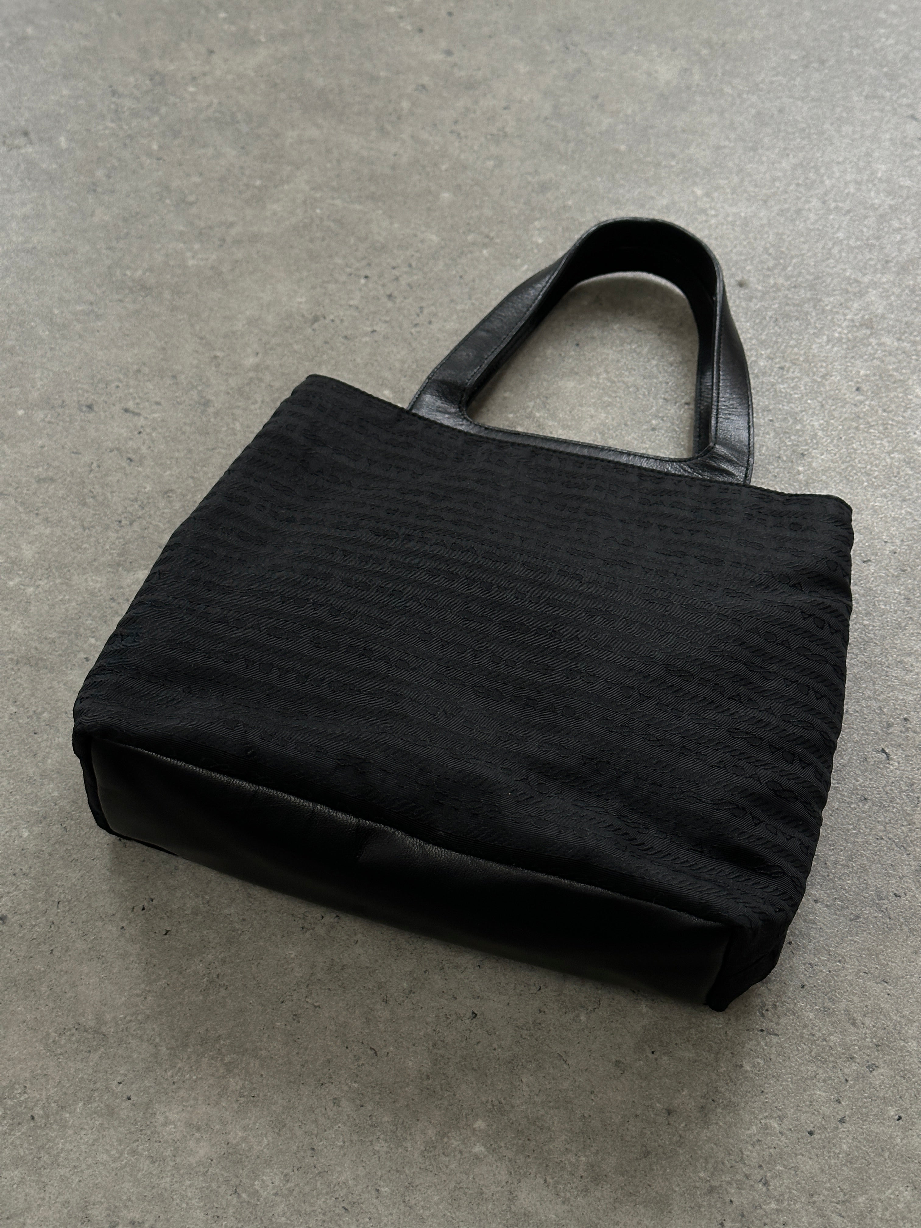 Prada 1990s Tessuto Monogram handbag with leather accents, showcasing a classic and stylish design.
