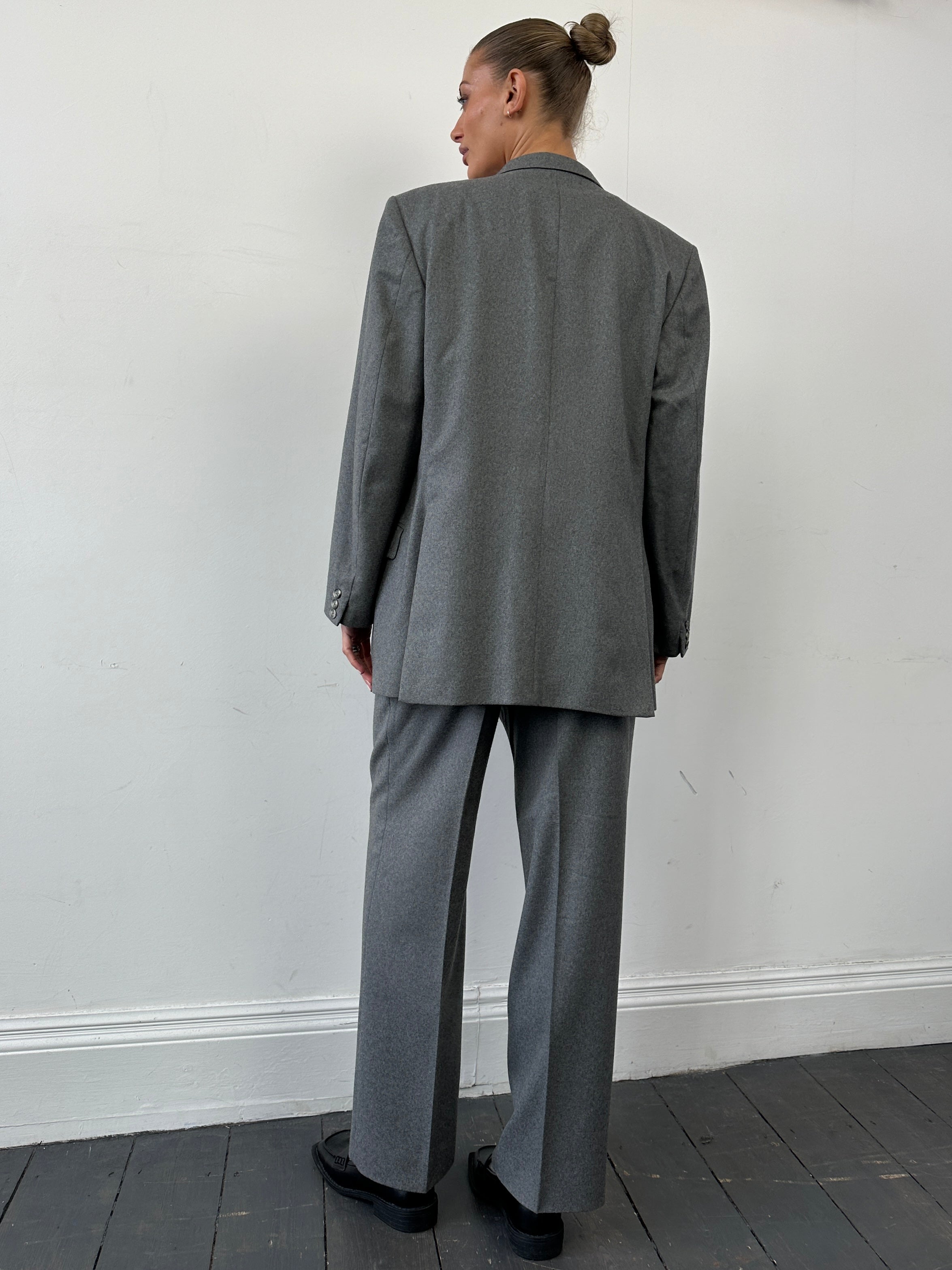 Christian Dior pure wool single-breasted jumpsuit in size 44R/W32, tailored fit with lapel collar and front buttons.