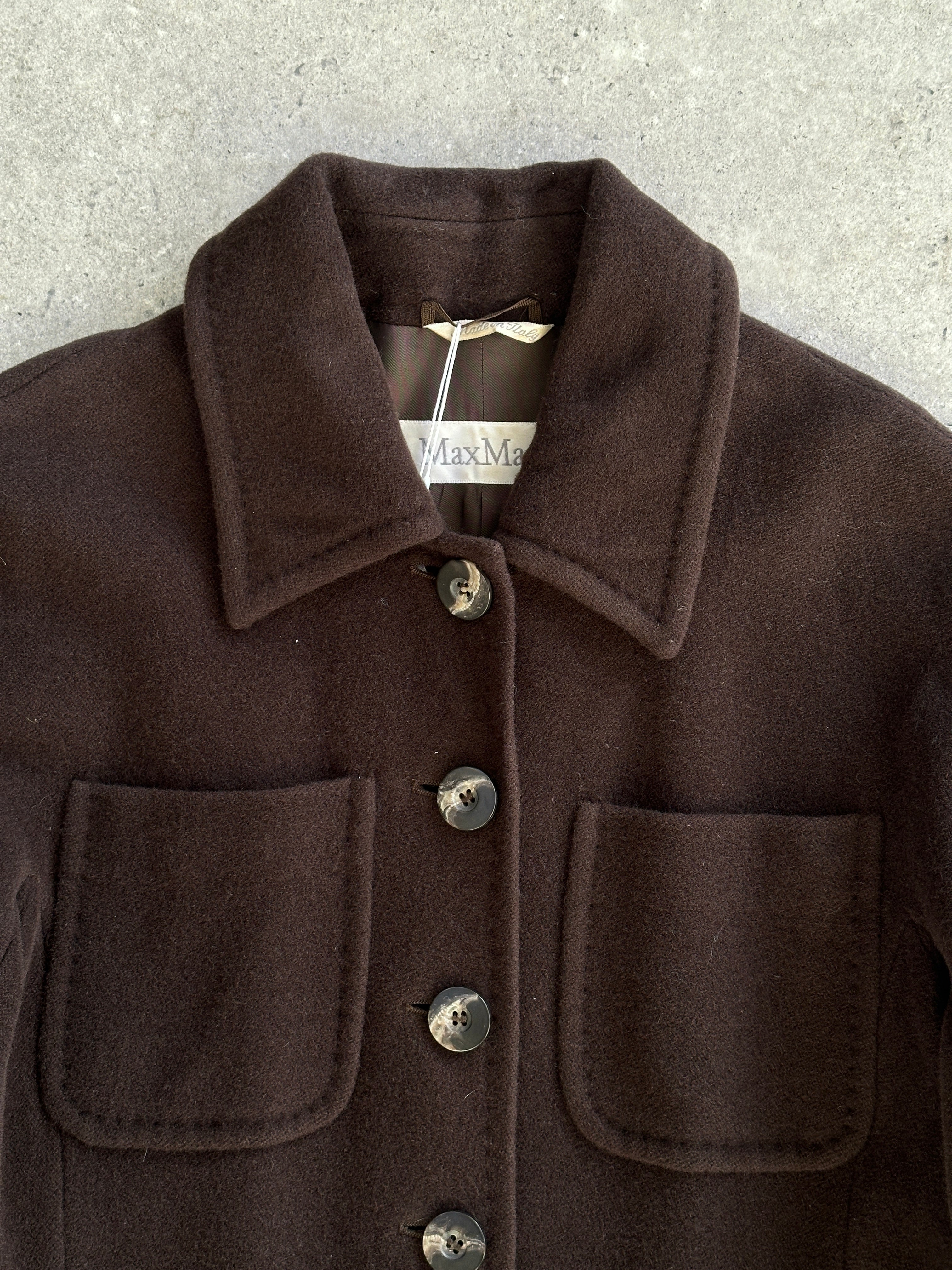 Max Mara pure wool A-line floor-length coat in size M, shown hanging with a tailored collar and sleek silhouette.