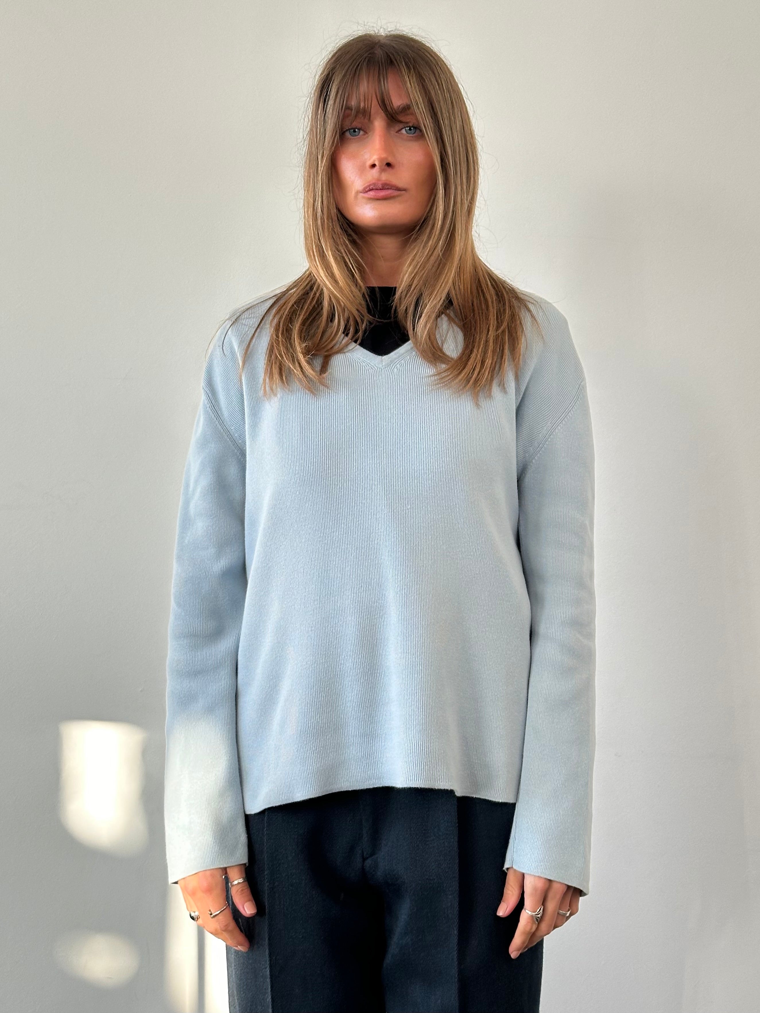 Armani Jeans pure cotton V-neck jumper in size large, featuring a classic design and soft fabric, displayed on a neutral background.