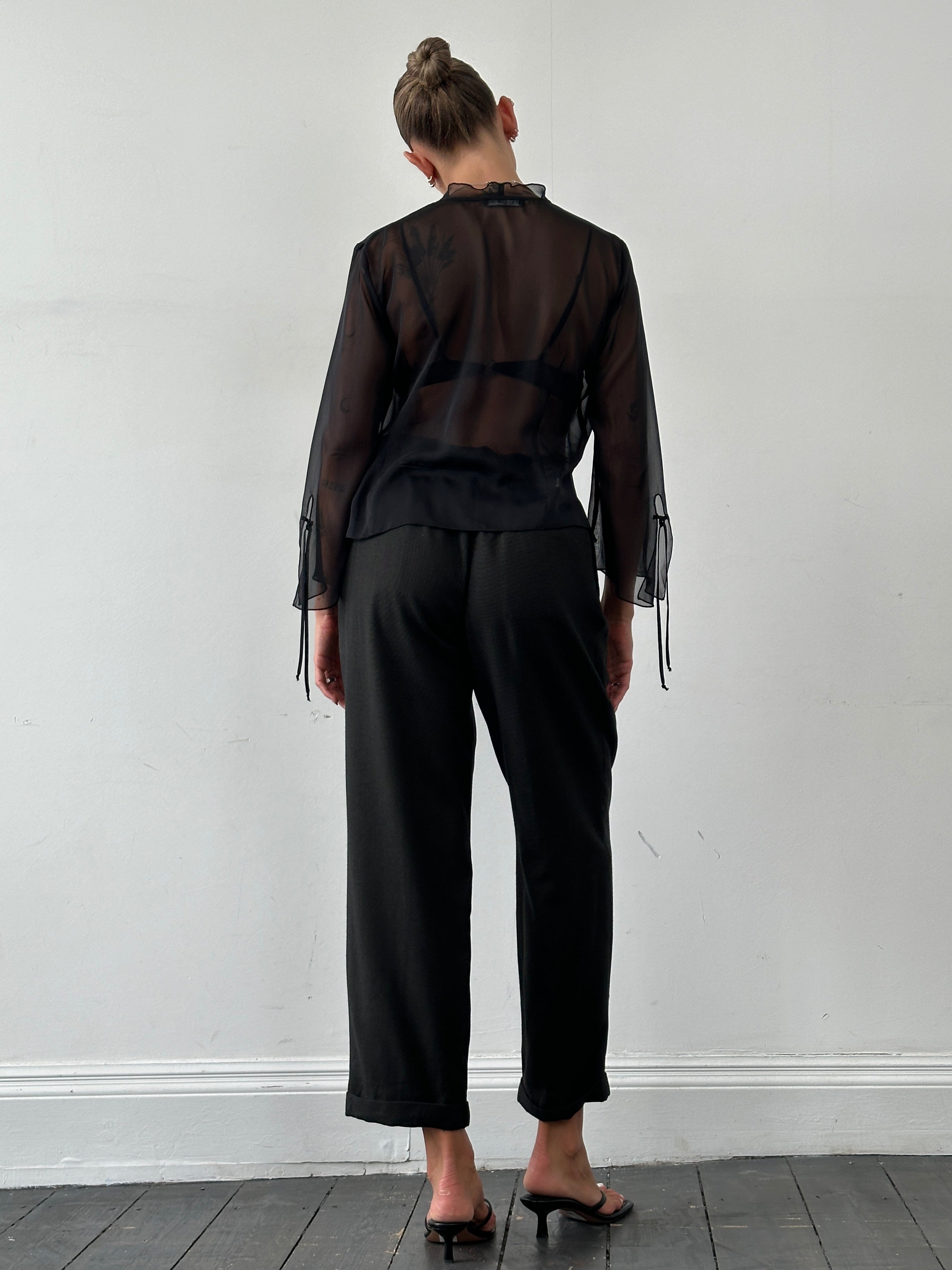 Christian Dior Monsieur wool tailored trousers in beige with straight legs and belt loops, size W36, hanging on a clothing rack.